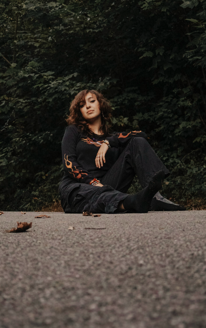 A series of artistic poses captured on a gravel path showing someone wearing black clothing in a natural setting.