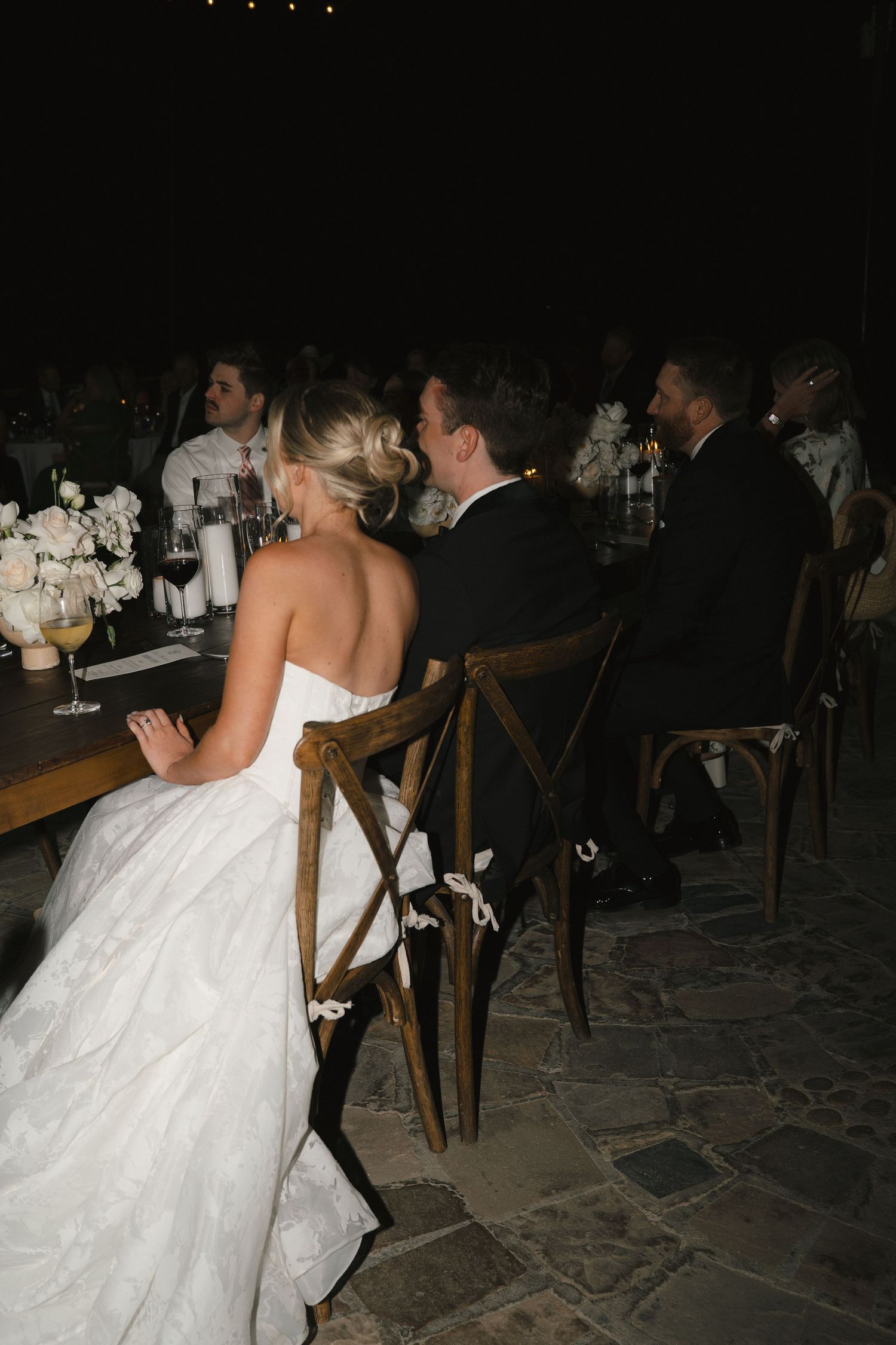 Candid photo of couple laughing while at reception