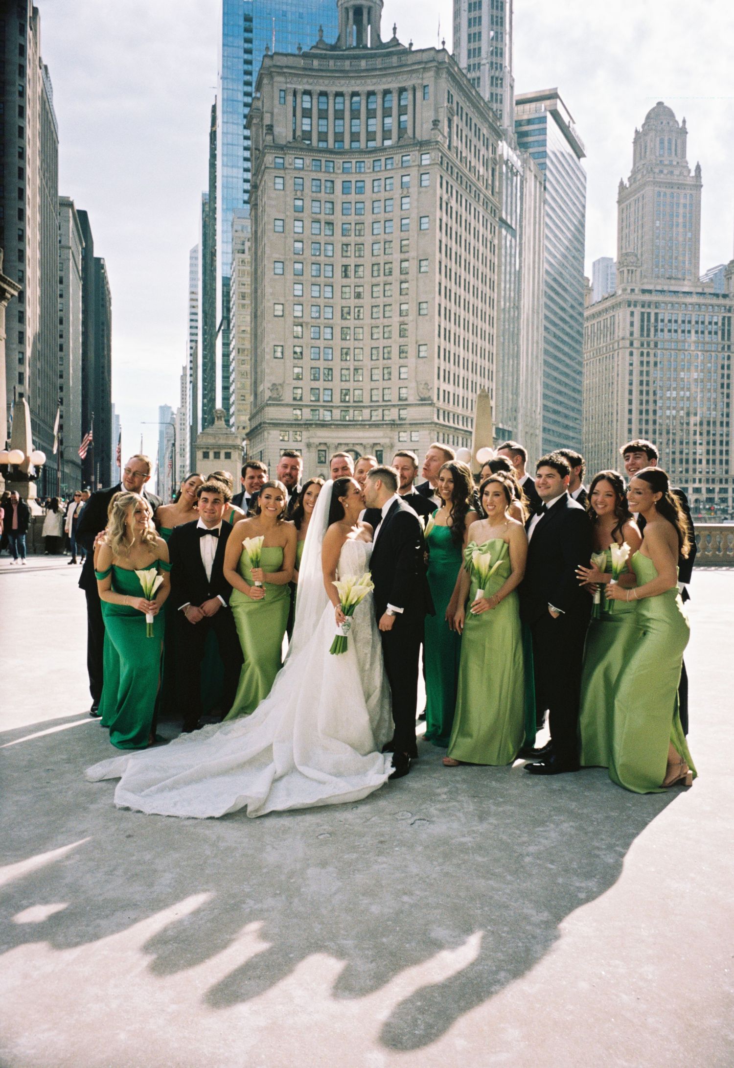 Just married couple walking down the aisle in Chicago with joyful guests, photographed in cinematic film wedding style.