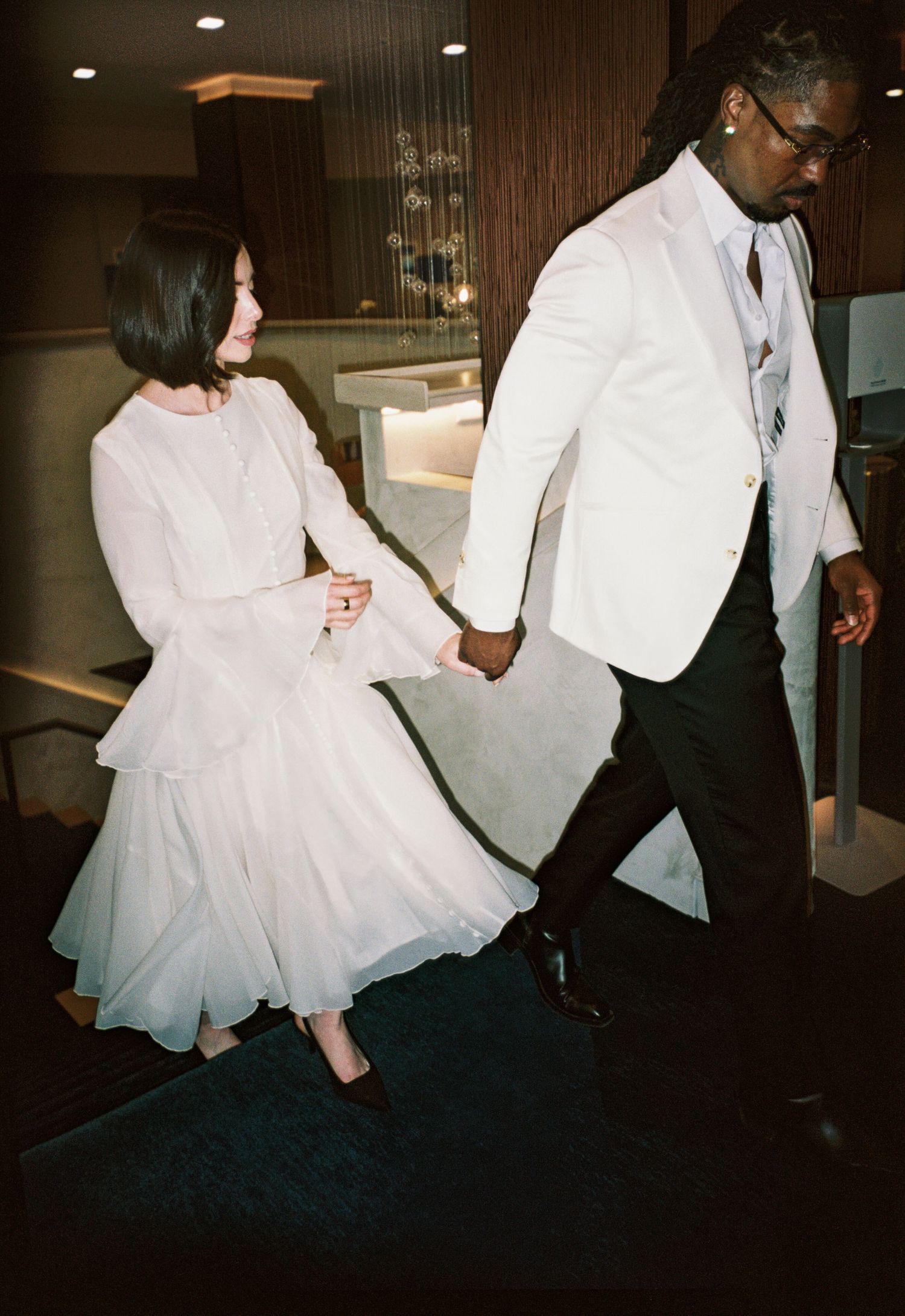 Candid photo of couple laughing while walking in Chicago