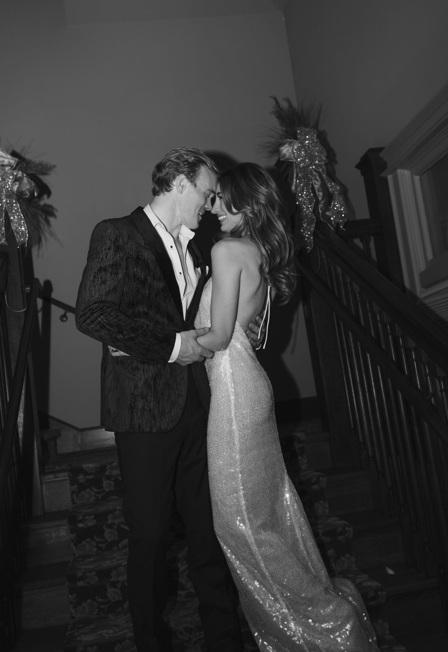 Luxury black tie wedding in Chicago with bride and groom entering their reception, stylish guests cheering, documentary style