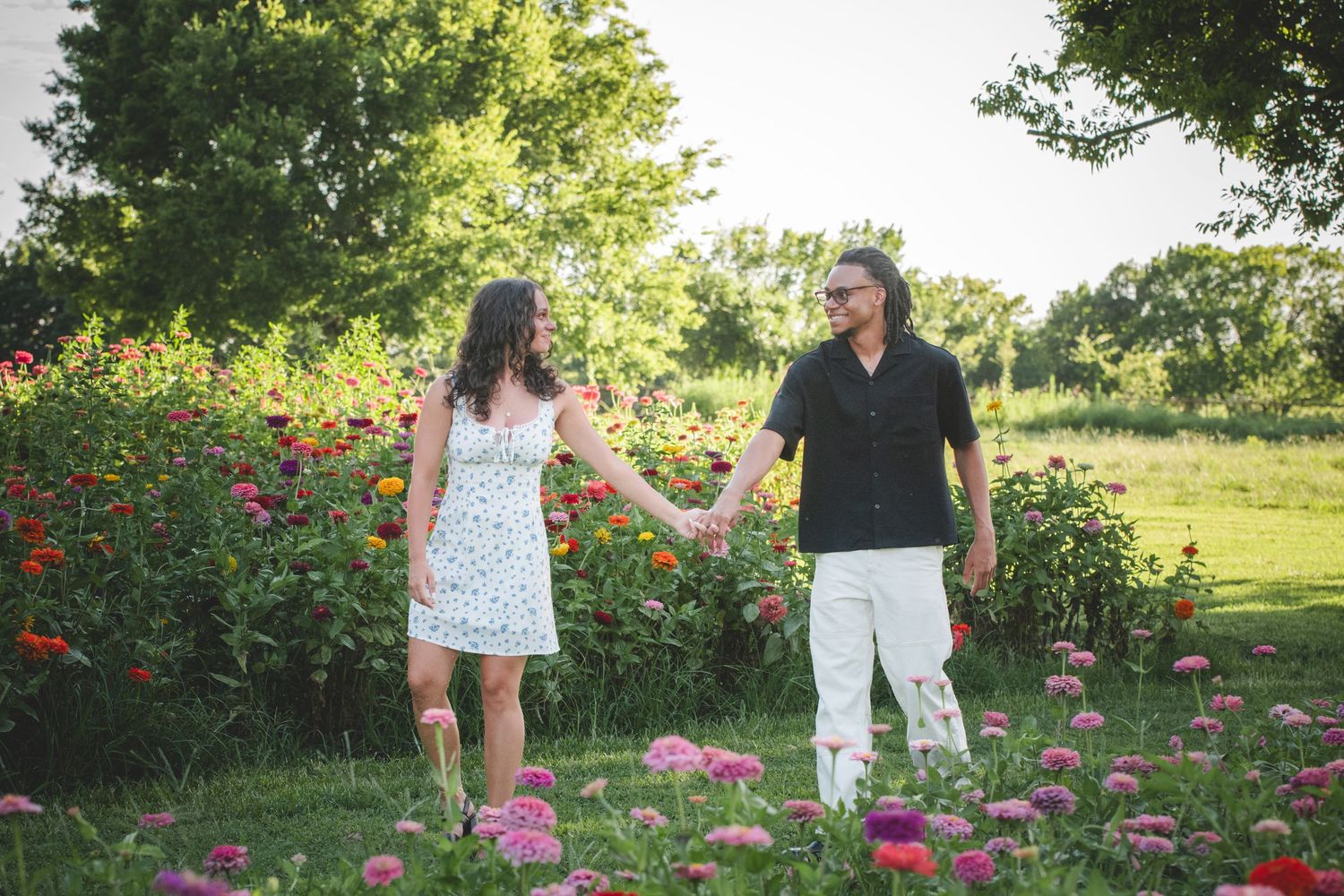 couple walking in a flower field