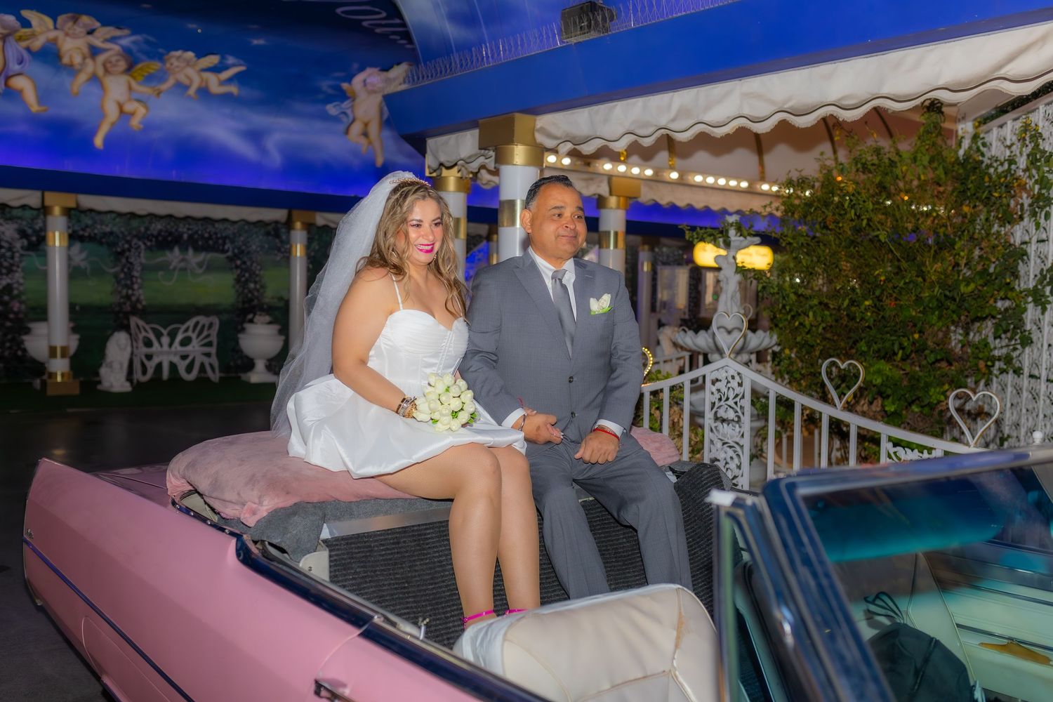 Bride and groom eloping at the Little White chapel in Las Vegas-pink Cadillac-Las Vegas elopement photographer