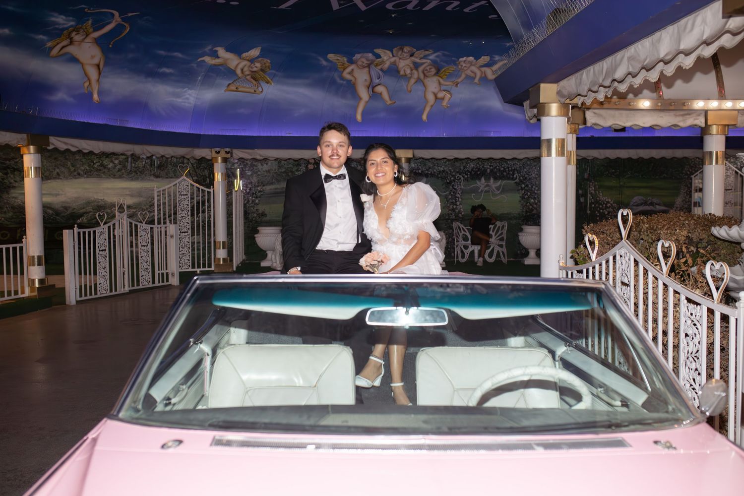Bride and groom eloping at the Little White chapel in Las Vegas-pink Cadillac-Las Vegas elopement photographer