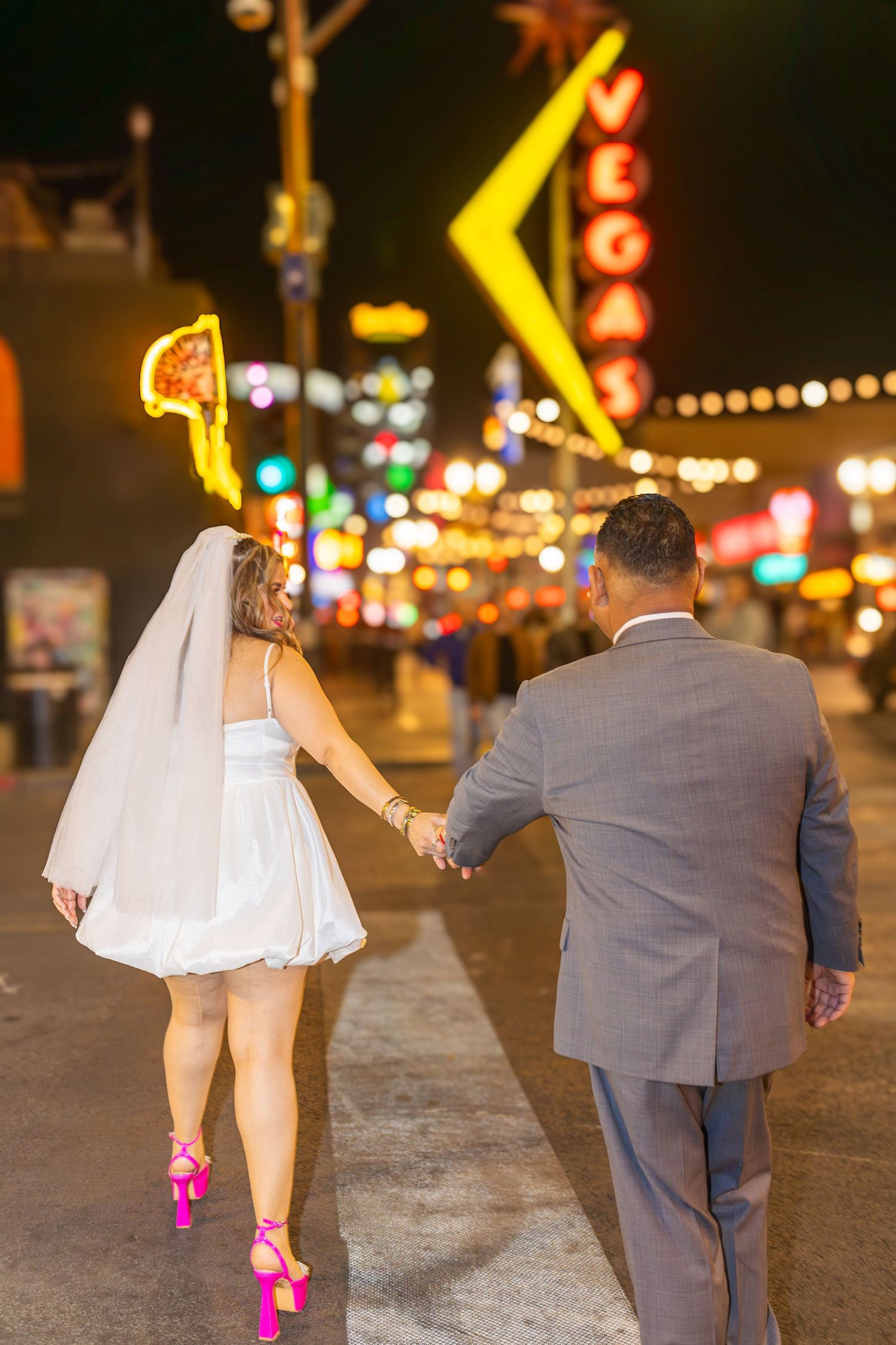 Couples eloping under neon lights on Fremont Street-Las Vegas photographer