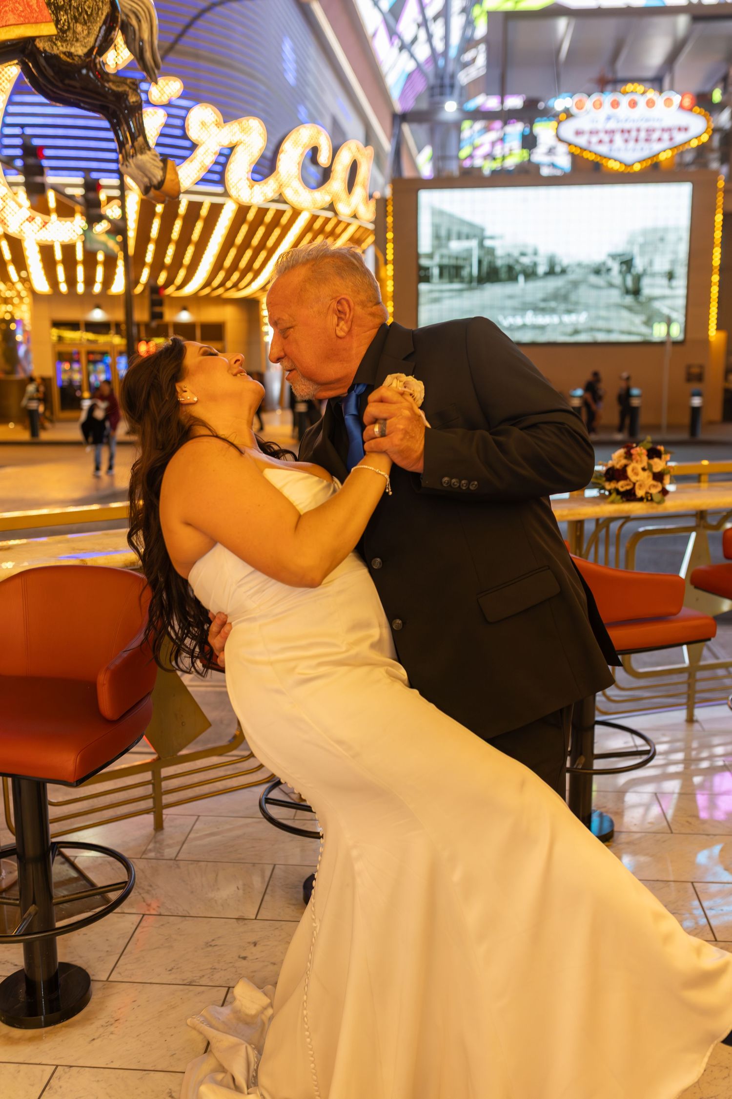 Couples eloping under neon lights on Fremont Street-Las Vegas photographer