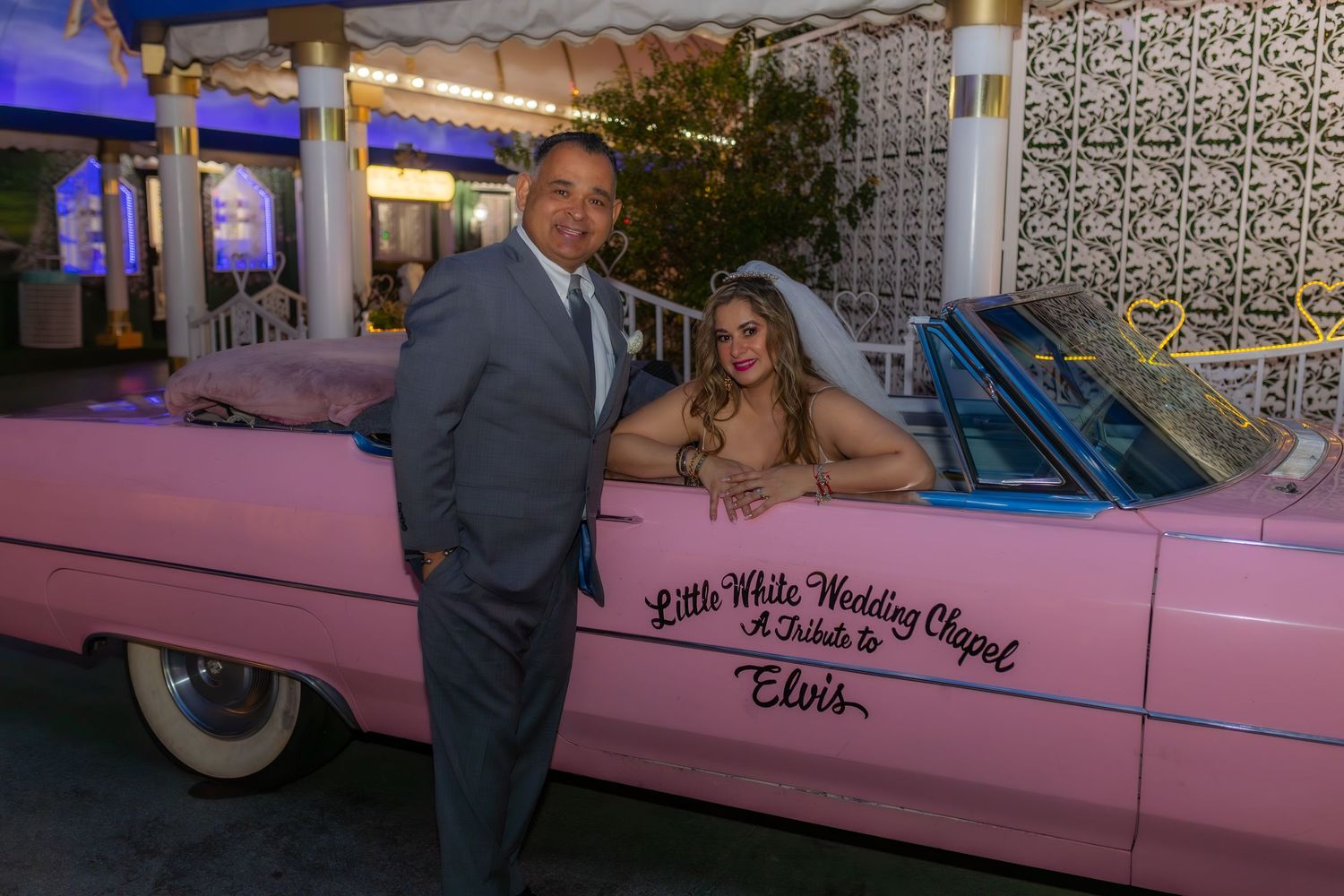 Bride and groom eloping at the Little White chapel in Las Vegas-pink Cadillac-Las Vegas elopement photographer