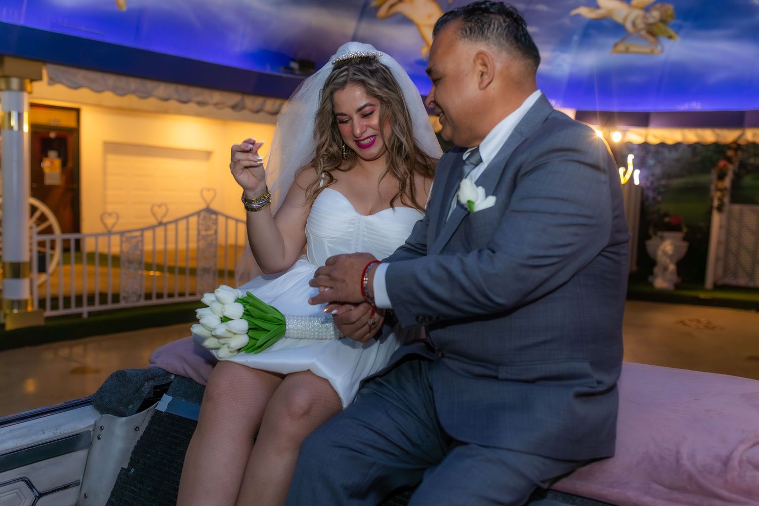 Bride and groom eloping at the Little White chapel in Las Vegas-pink Cadillac-Las Vegas elopement photographer