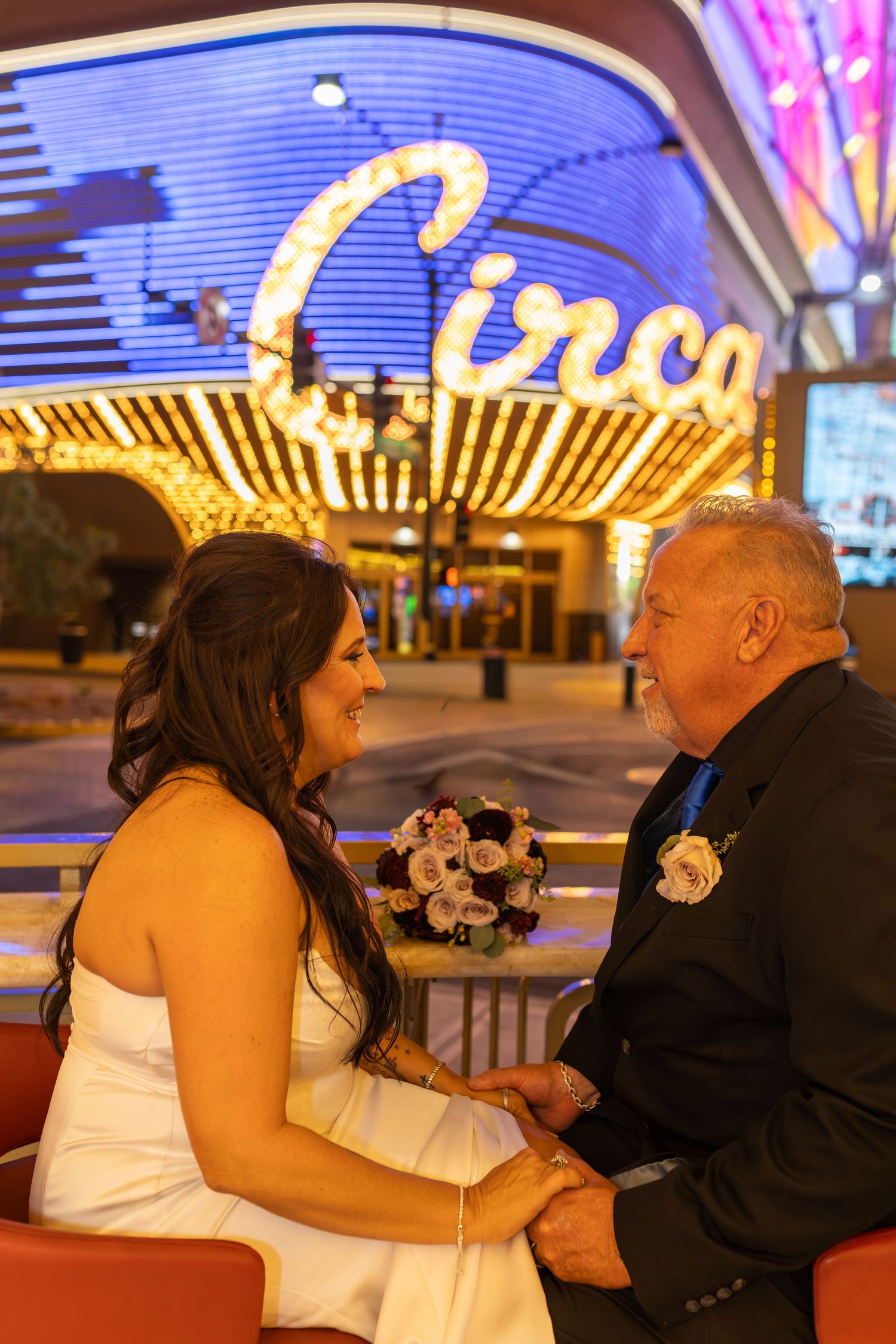 Couples eloping under neon lights on Fremont Street-Las Vegas photographer