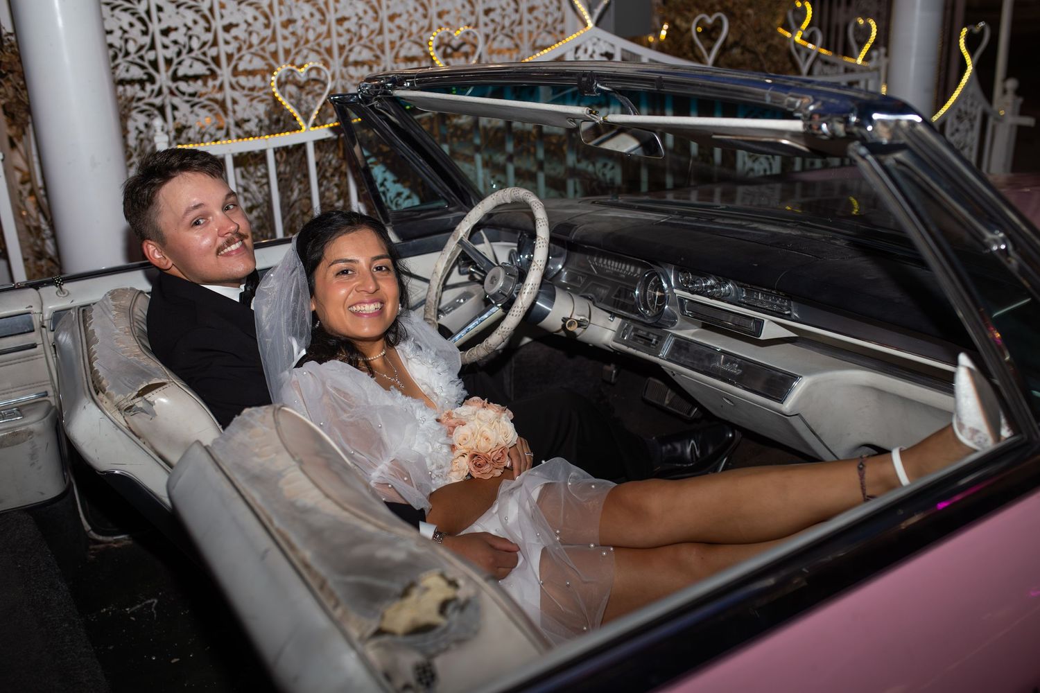 Bride and groom eloping at the Little White chapel in Las Vegas-pink Cadillac-Las Vegas elopement photographer