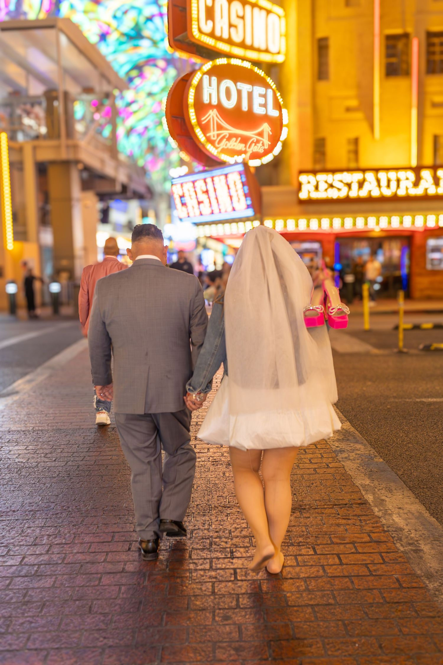Couples eloping under neon lights on Fremont Street-Las Vegas photographer