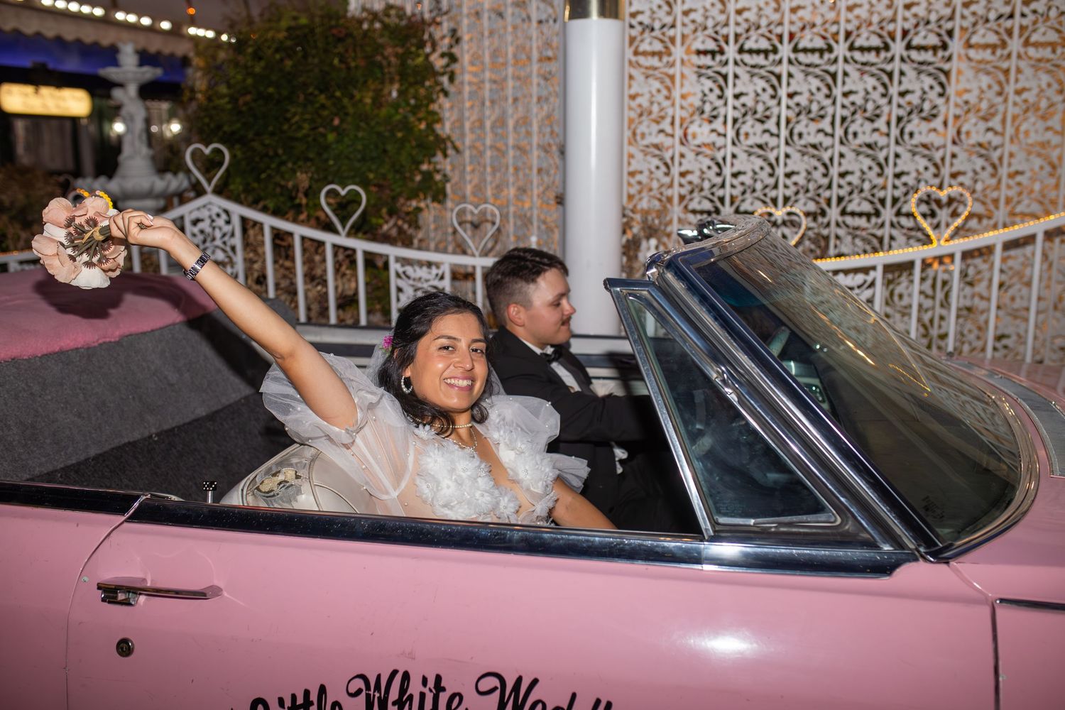 Bride and groom eloping at the Little White chapel in Las Vegas-pink Cadillac-Las Vegas elopement photographer