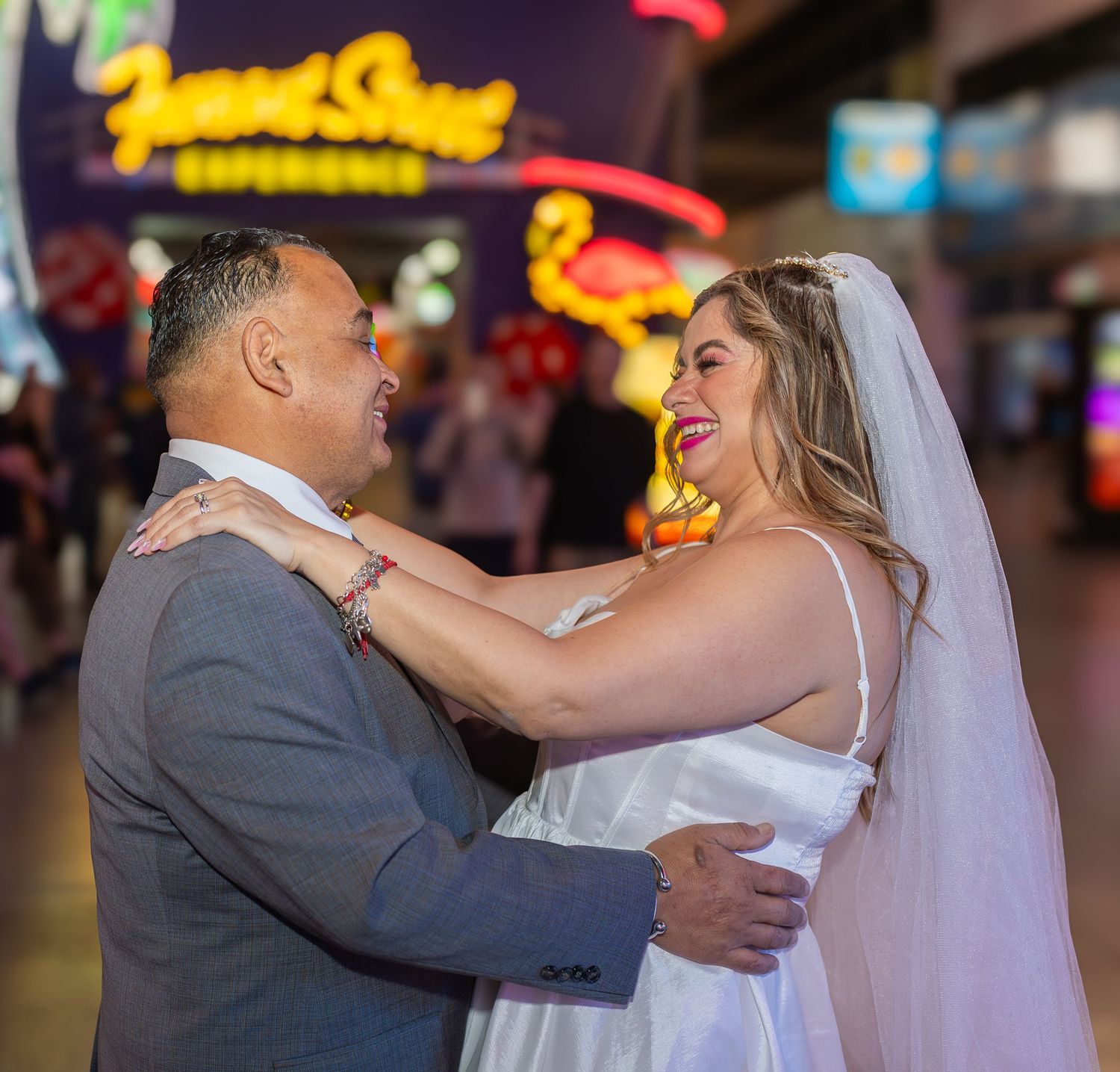 Couples eloping under neon lights on Fremont Street-Las Vegas photographer
