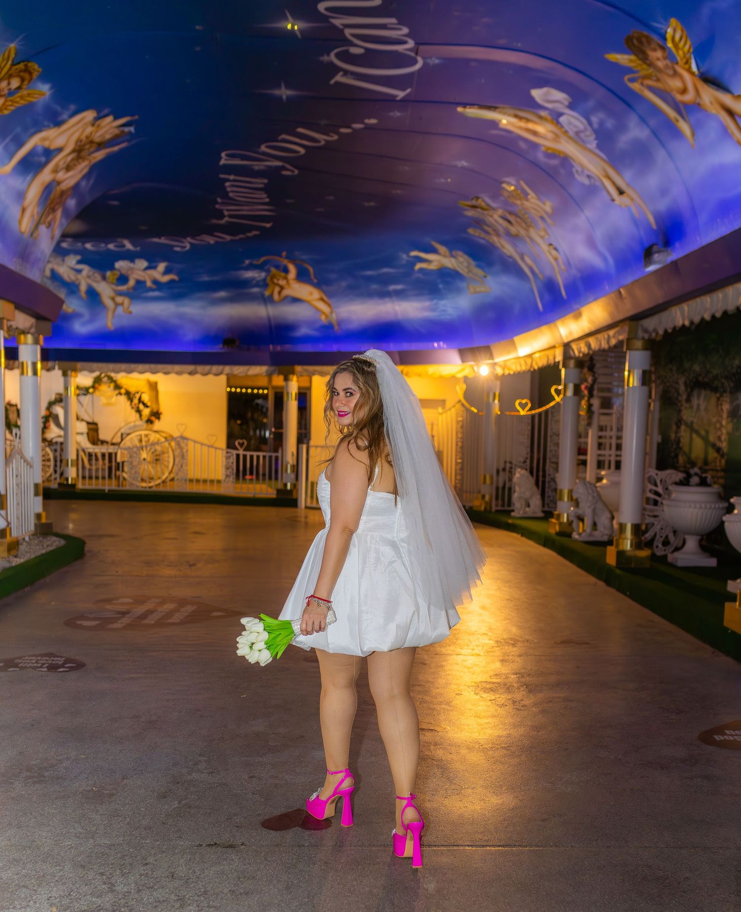 Bride and groom eloping at the Little White chapel in Las Vegas-pink Cadillac-Las Vegas elopement photographer