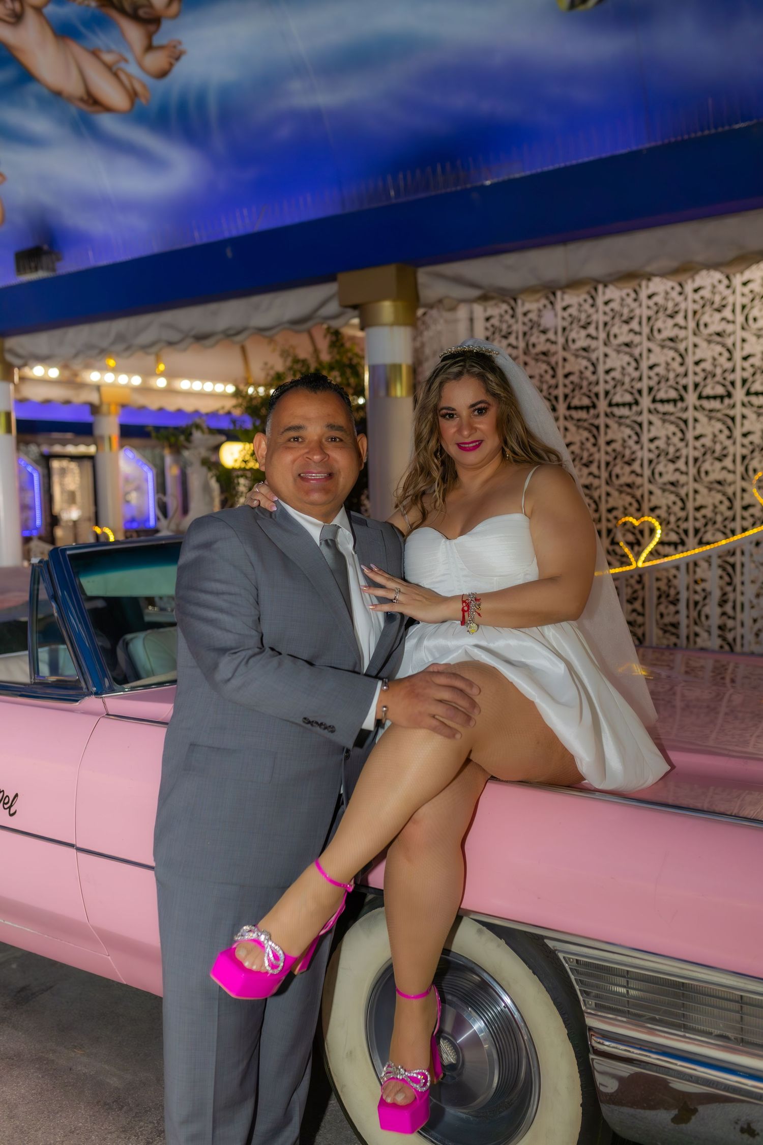 Bride and groom eloping at the Little White chapel in Las Vegas-pink Cadillac-Las Vegas elopement photographer