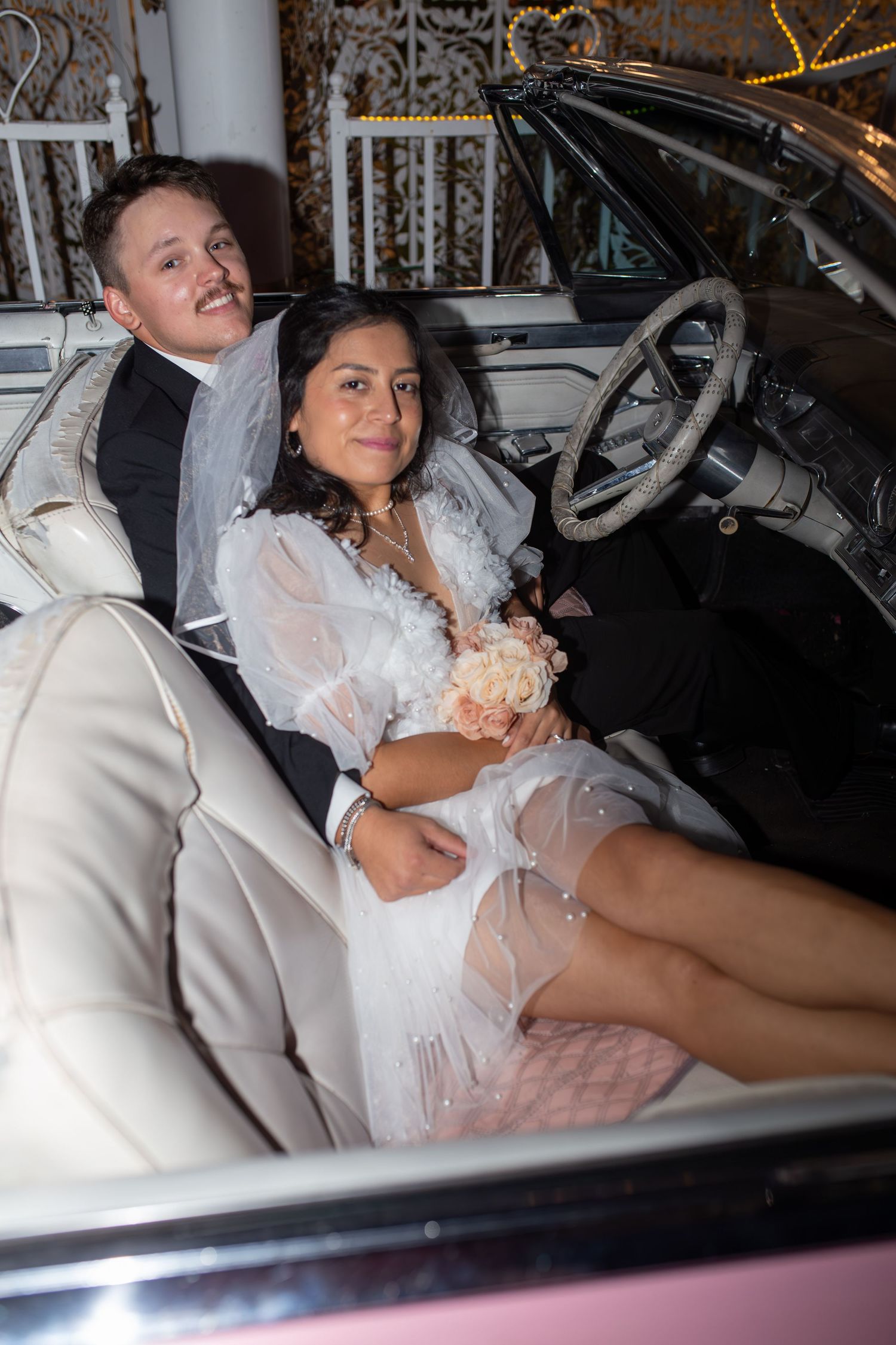 Bride and groom eloping at the Little White chapel in Las Vegas-pink Cadillac-Las Vegas elopement photographer