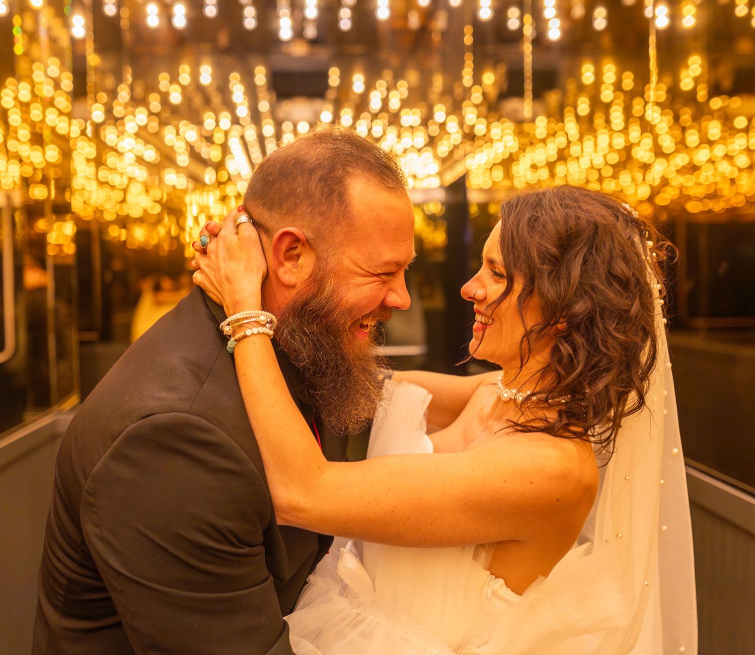 Couple gets married under the Las Vegas lights of the city beaming behind them with a loving gaze by elopement photographer