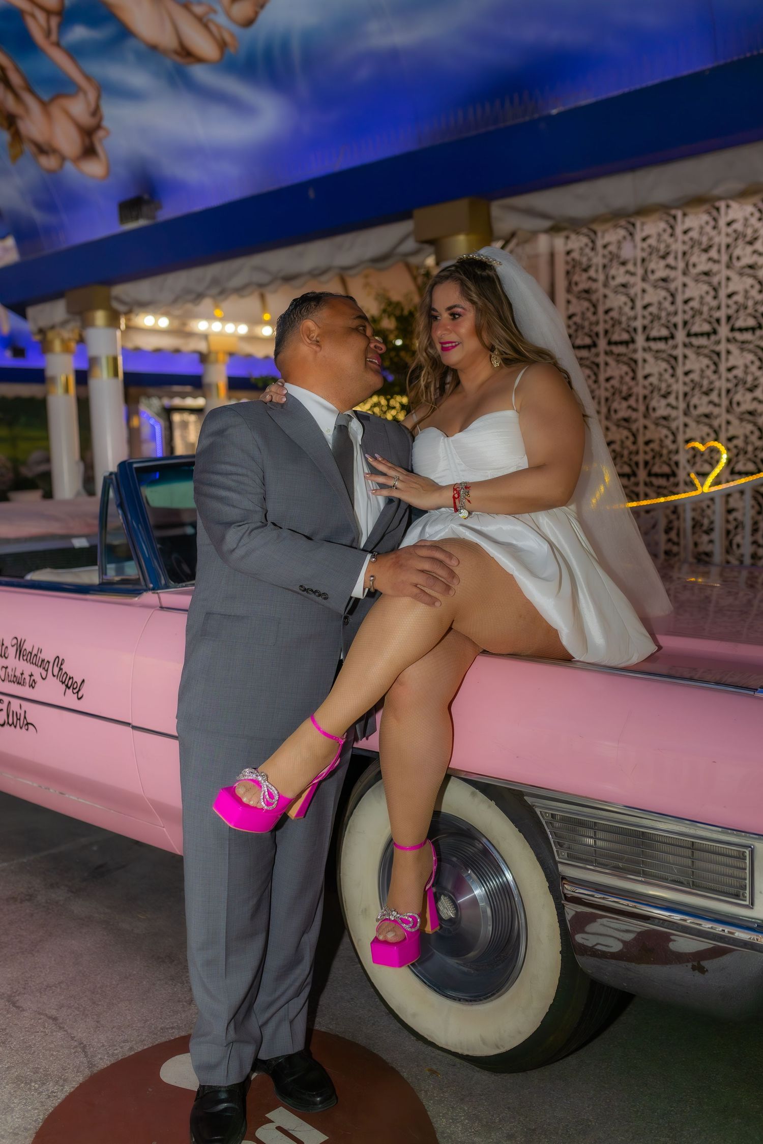 Bride and groom eloping at the Little White chapel in Las Vegas-pink Cadillac-Las Vegas elopement photographer