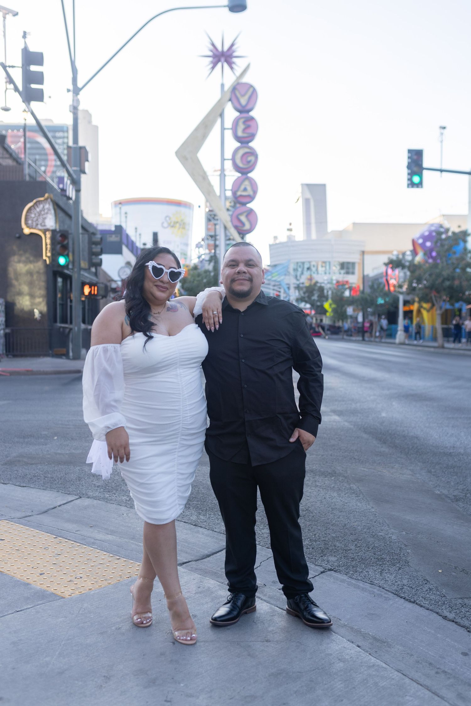 Bride and groom posing in iconic downtown Las Vegas by intimate elopement photographer
