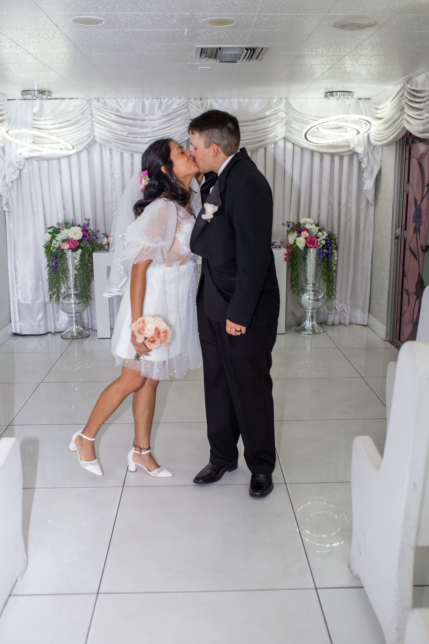 Bride and groom eloping at the Little White chapel in Las Vegas-pink Cadillac-Las Vegas elopement photographer