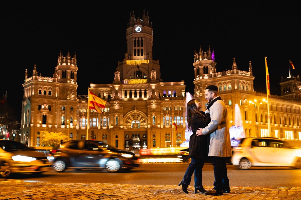 Historic Plaza Cibeles illuminated at night with golden lighting and grand architecture for a surprise weding proposal.