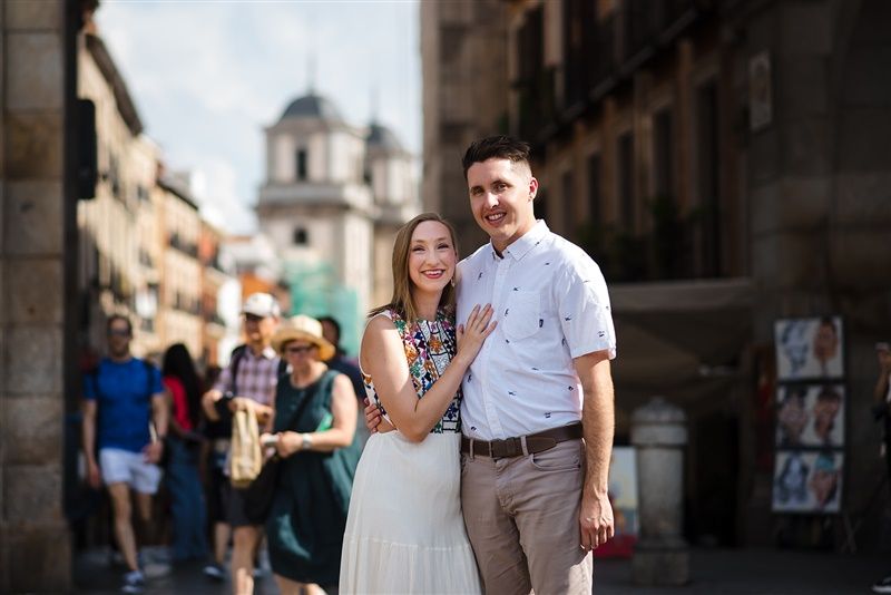Couple strolling through historic Madrid City streets.