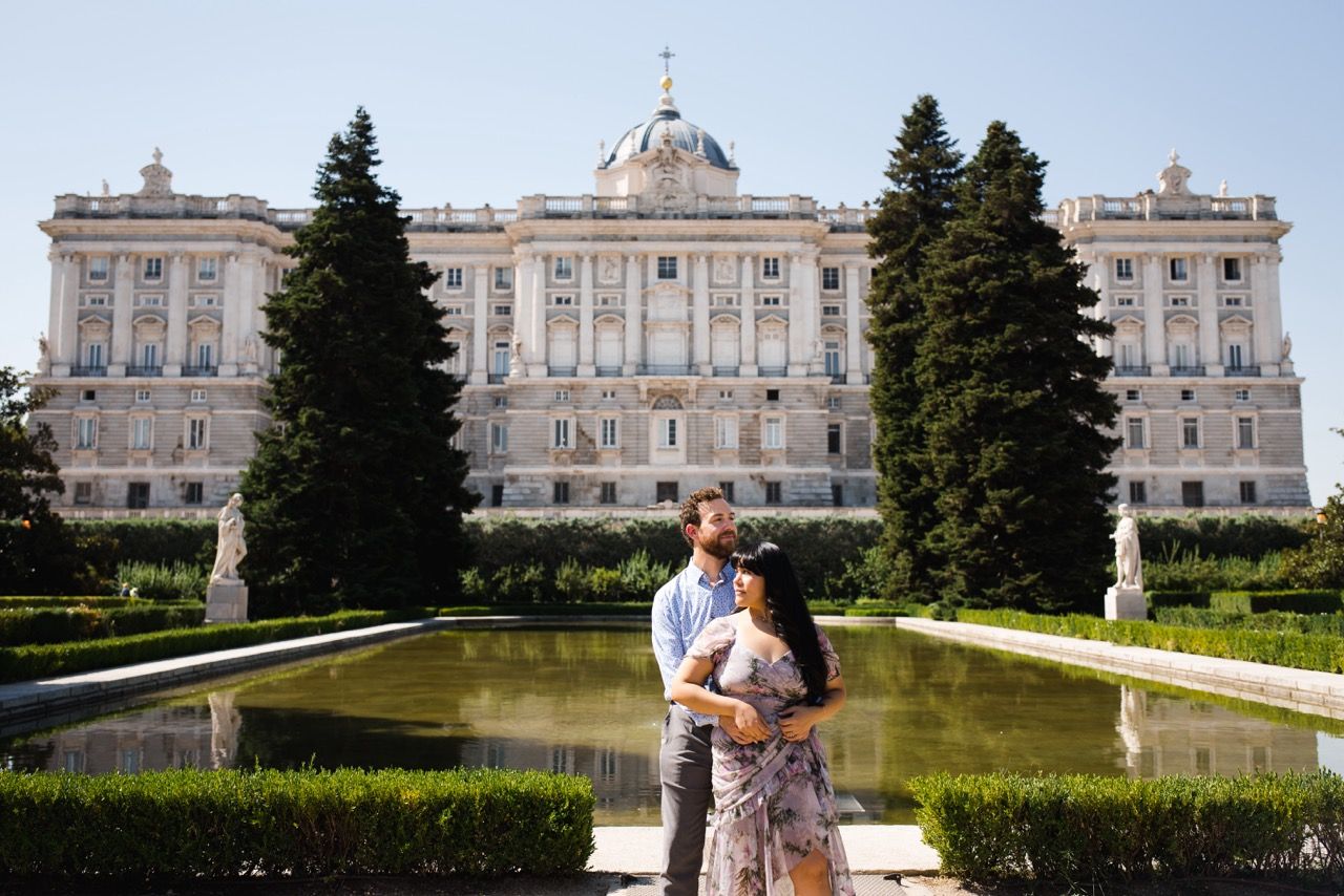 View of Madrid's Royal Palace with its neoclassical architecture and manicured gardens.