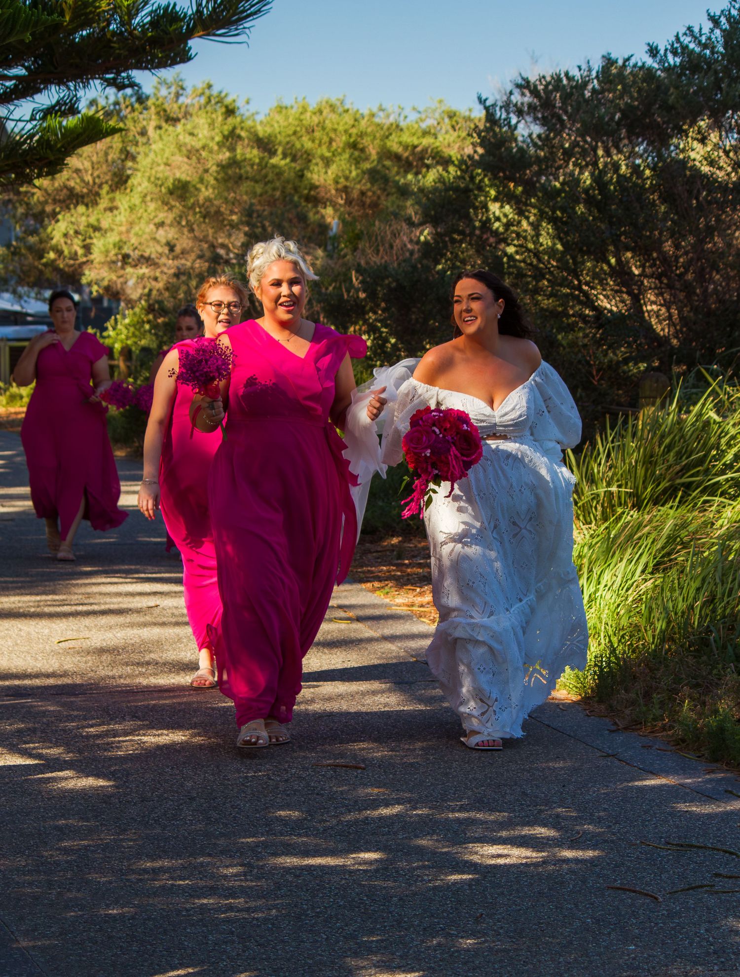 Bride and bridesmaid walking down the path toward the ceremony location, emotional moment before the wedding vows.