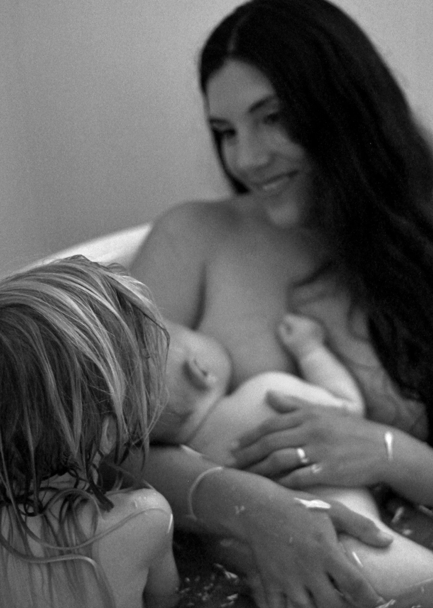 Candid moment of sibling love in a lifestyle motherhood photoshoot by A Lasting Impression Photography.