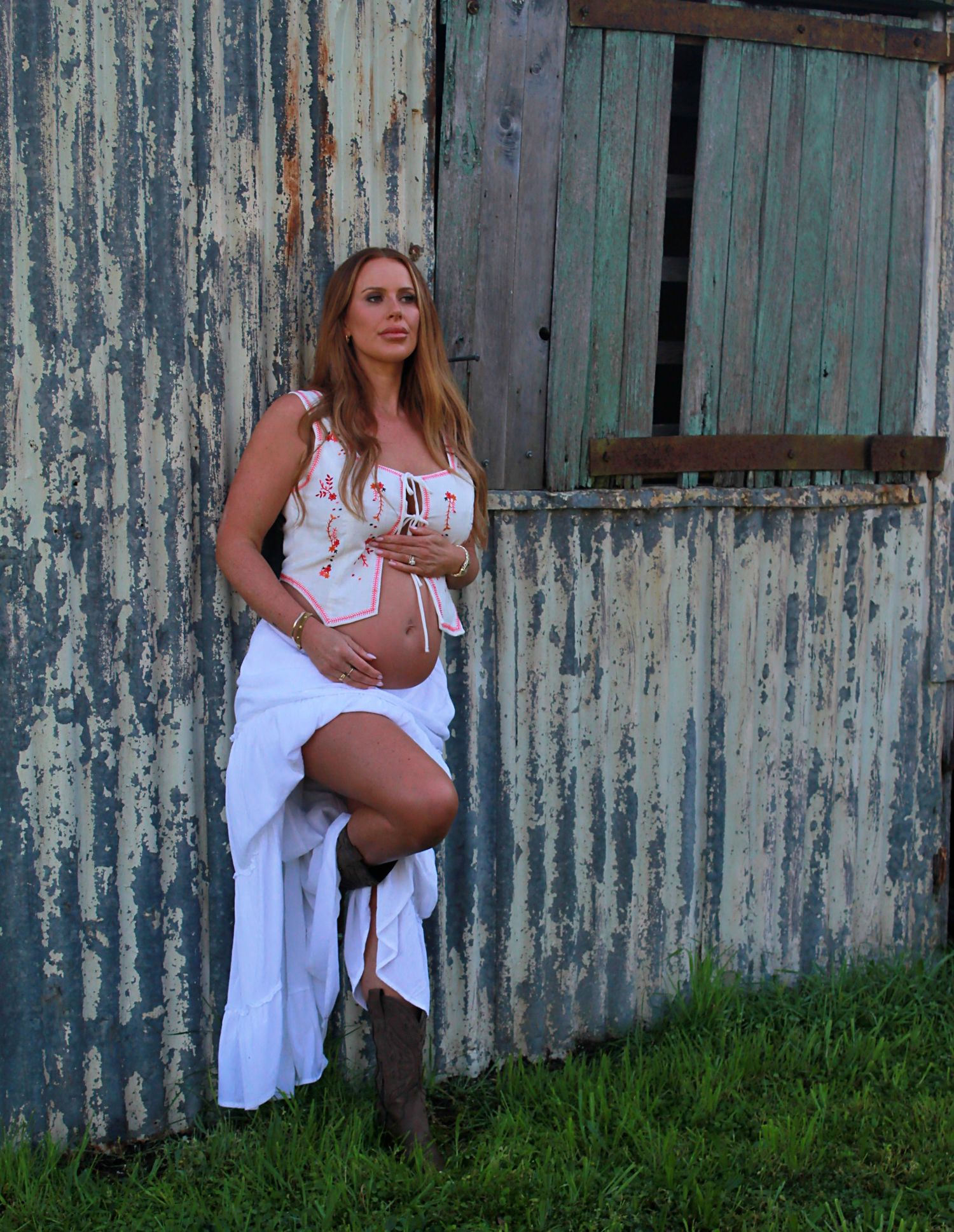 Outdoor maternity photoshoot featuring a mumma to be by a rustic barn by A Lasting Impression Photography.