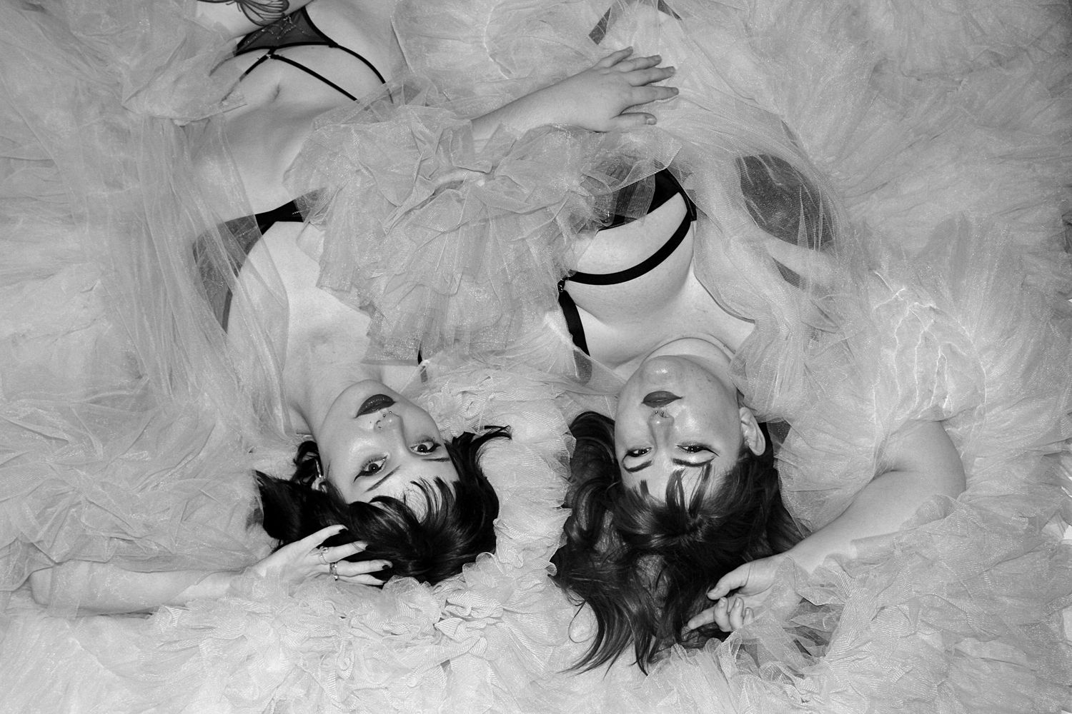 Black & white boudoir portrait of two friends in soft tulle robes, captured by A Lasting Impression Photography in the Illawarra.