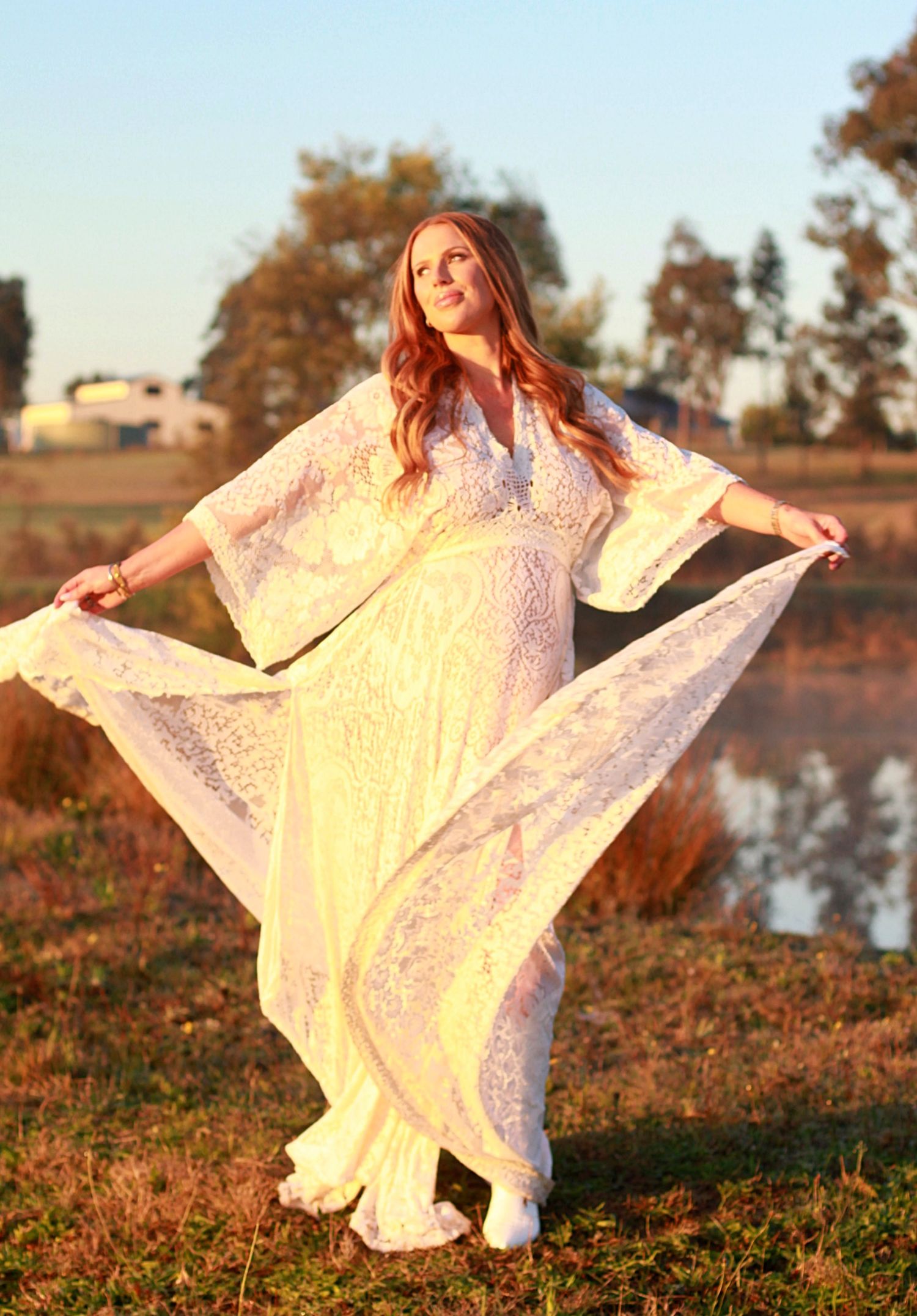 Natural maternity moment of a mumma-to-be spinning her dress at sunrise