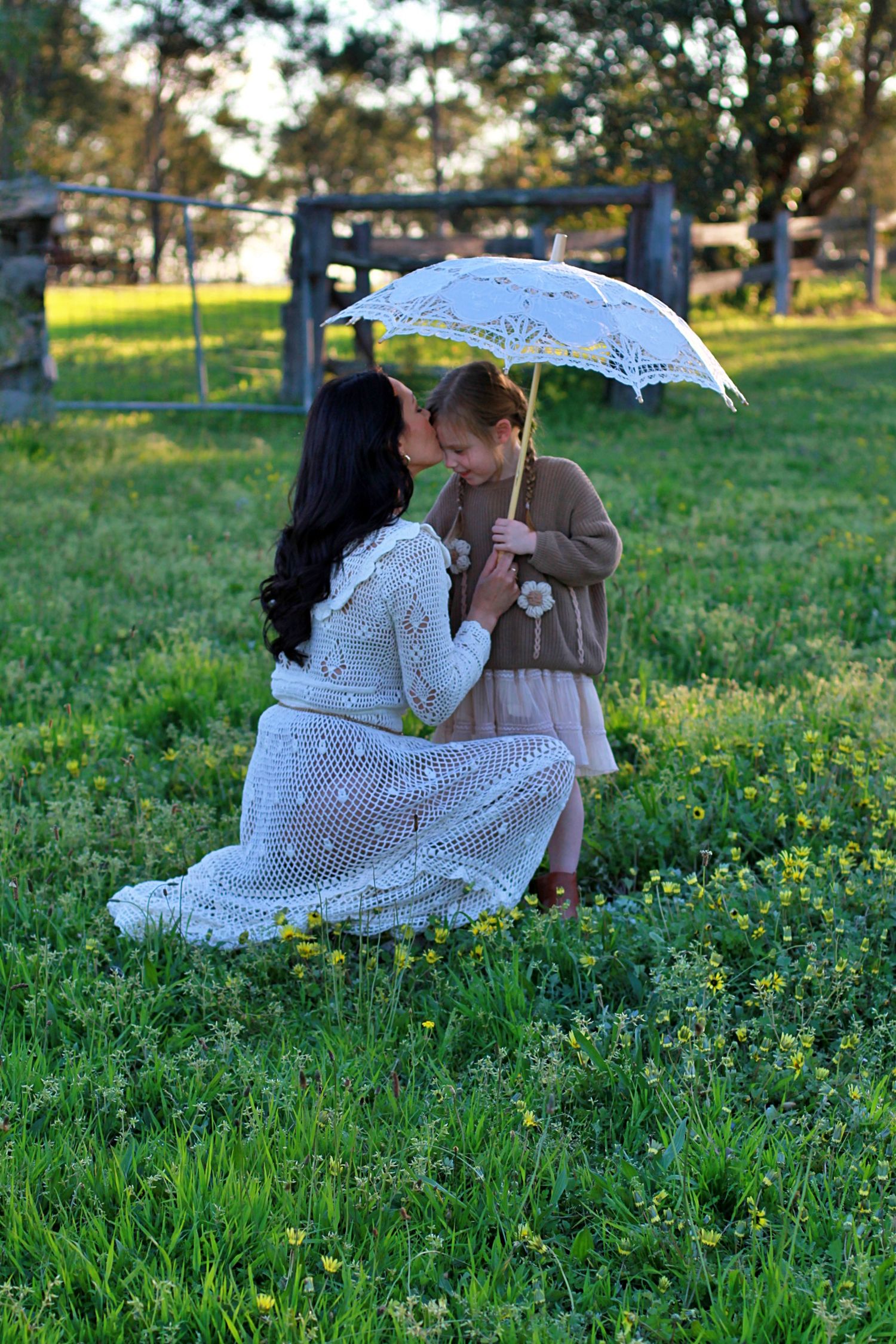 Mum and daughter sharing a quiet moment in nature during a family session