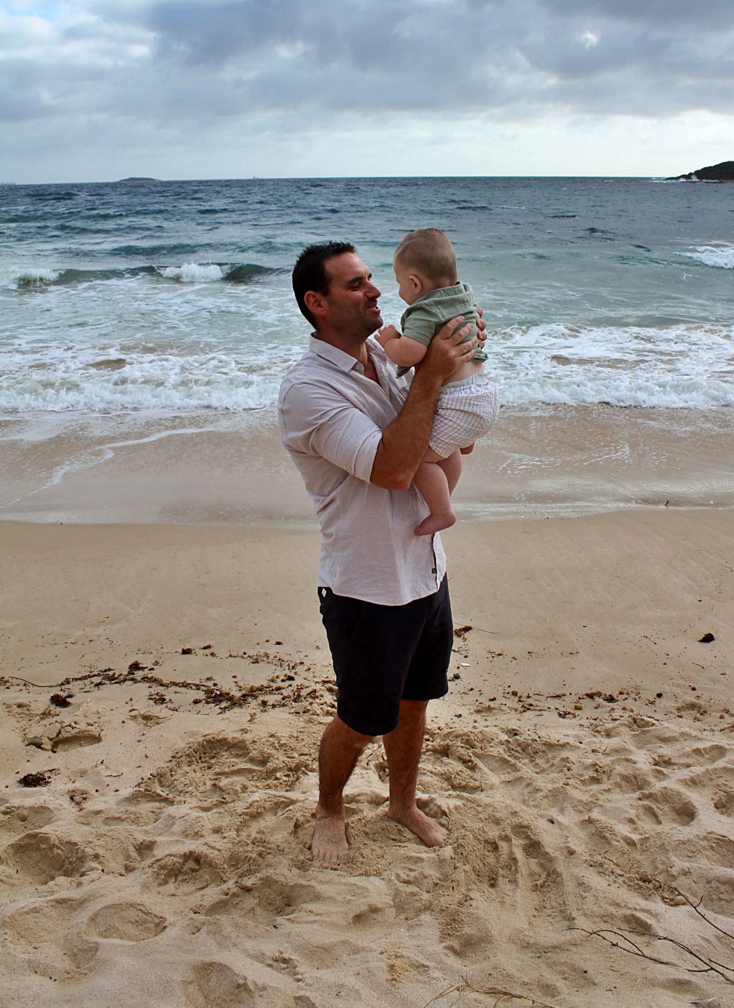 Dad and son portraits on the beach in the Illawarra, capturing loving connection and natural coastal moments.