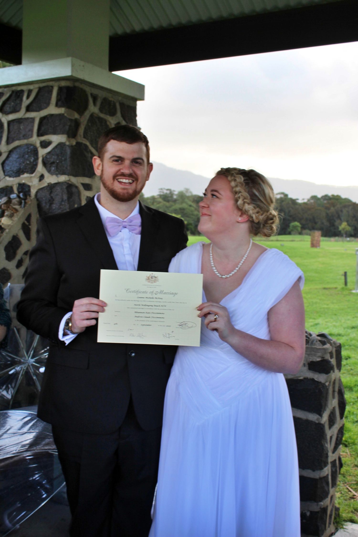 Bride and groom holding wedding certificate during micro wedding in the Illawarra