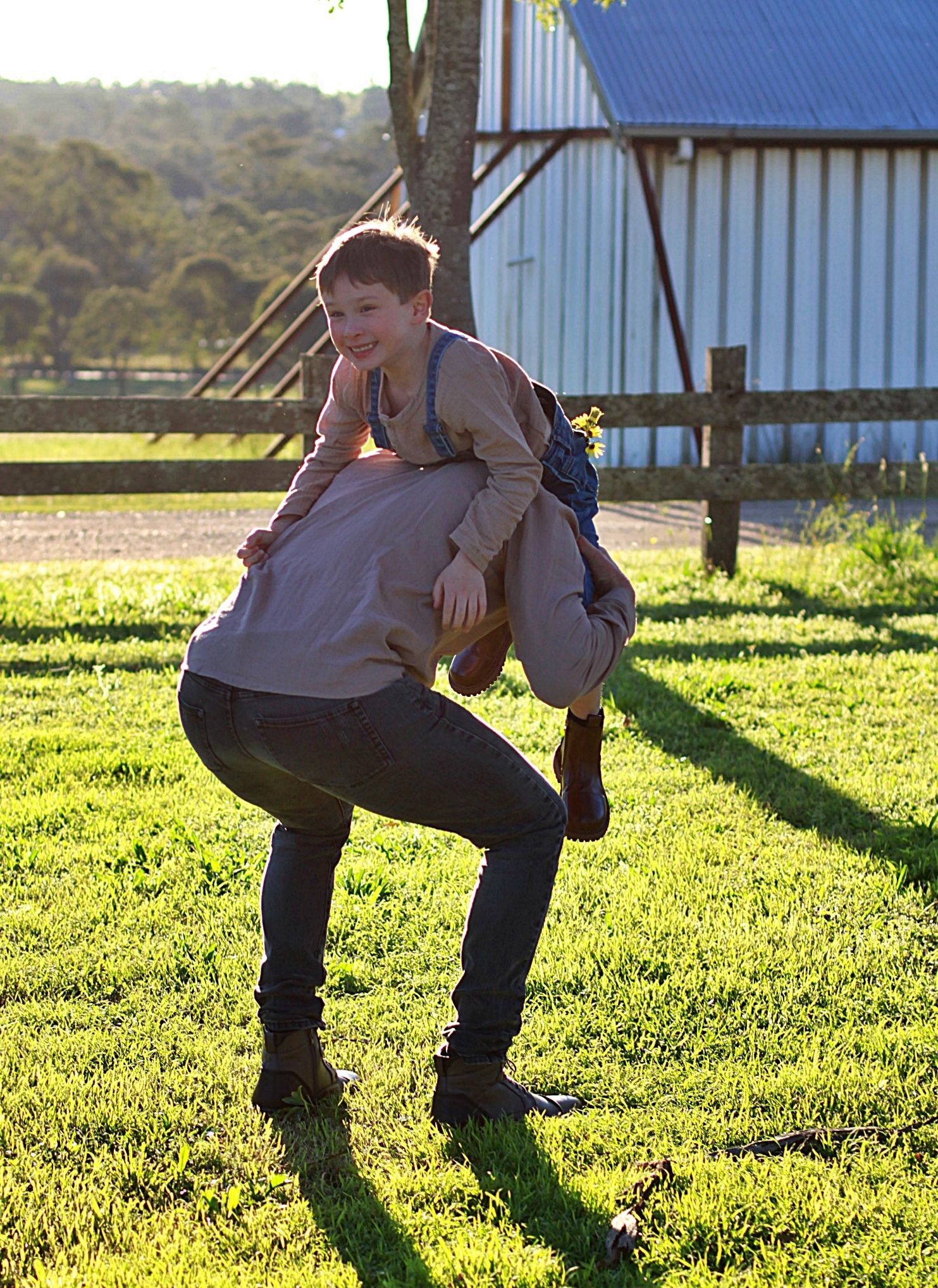 Candid moment of a boy been picked up and laughing during a family session