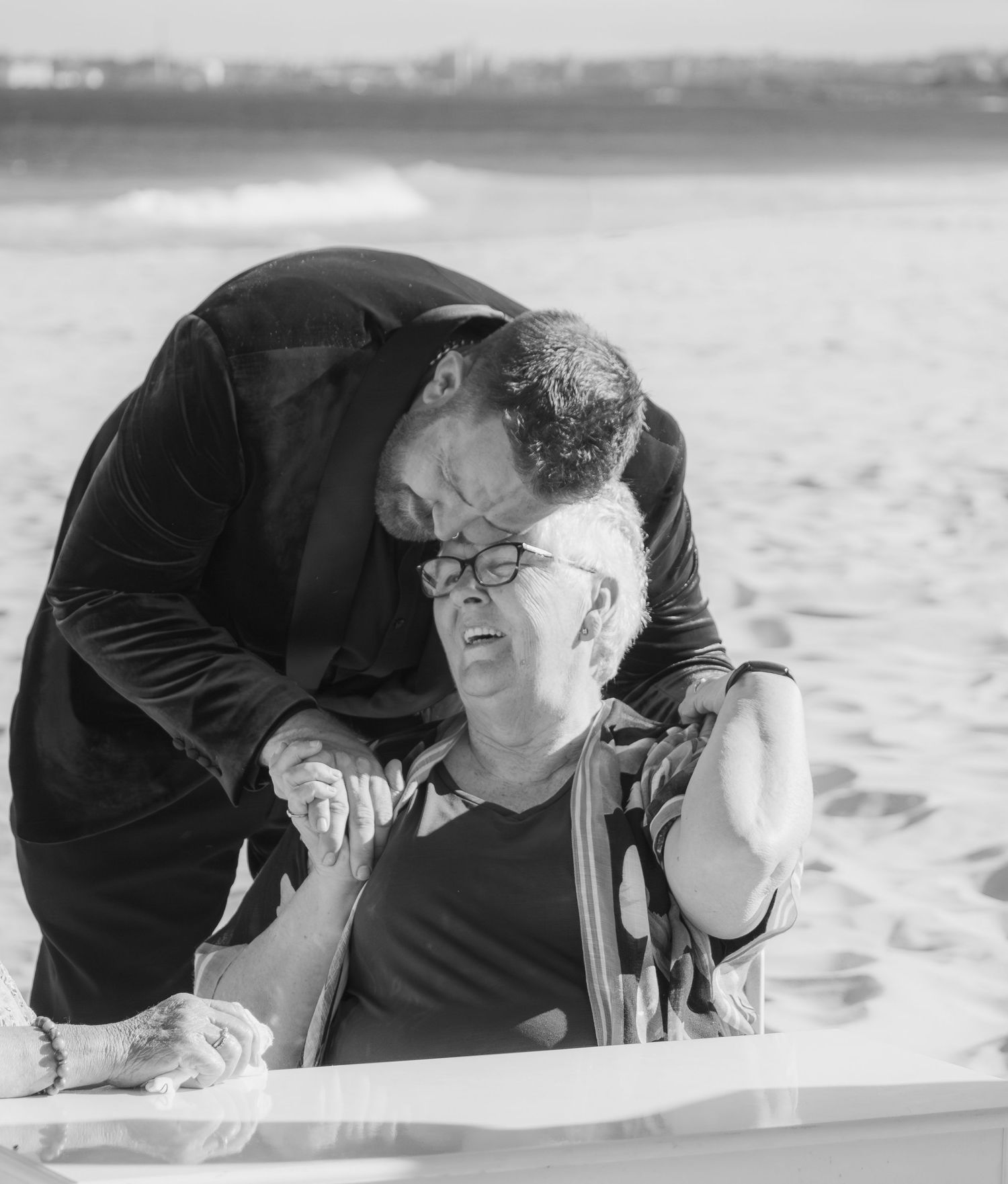 Groom hugging his mum after the ceremony in a candid family moment.