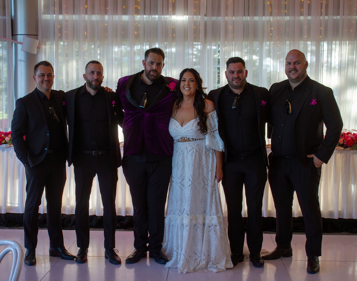Bride and groom portrait with the groomsmen during bridal party portraits.