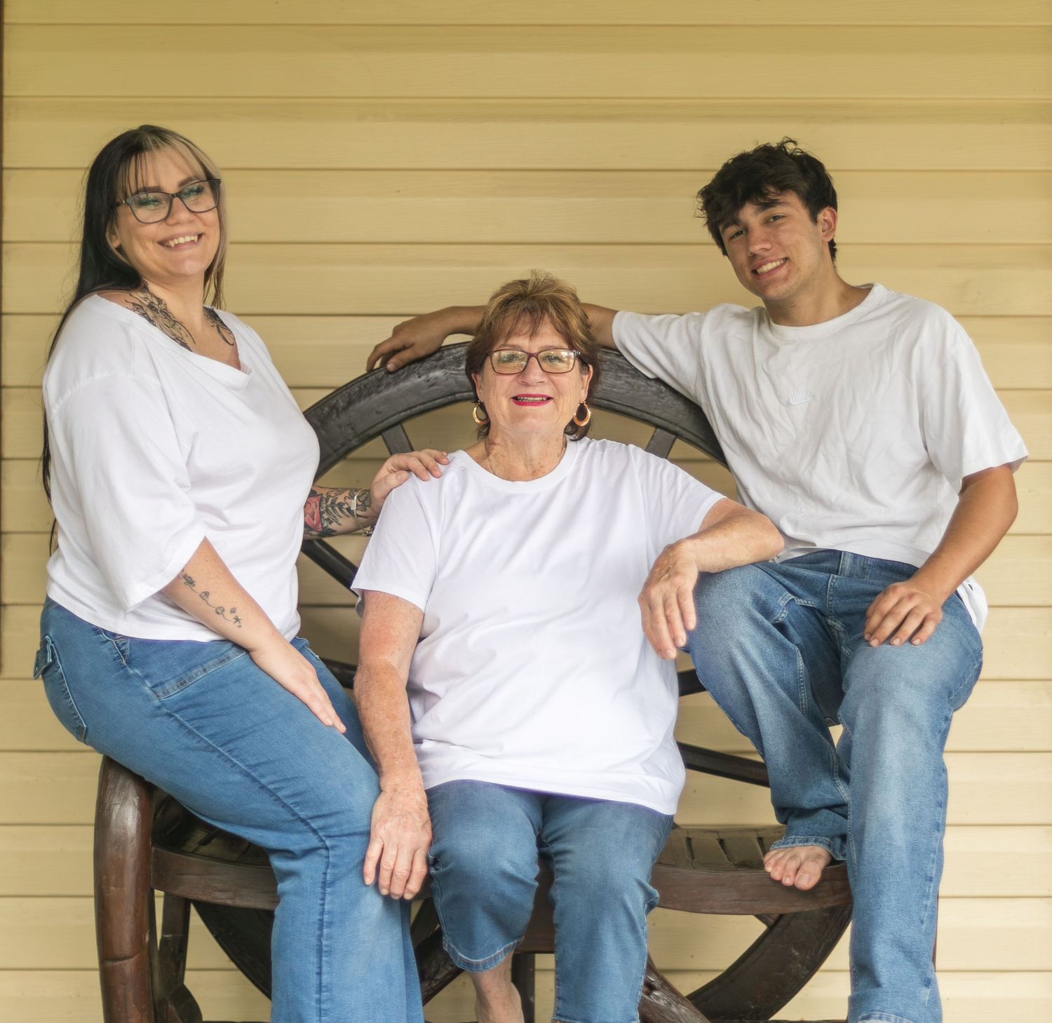 Grandma sitting with her granddaughter and grandson during an outdoor generational family photography session.