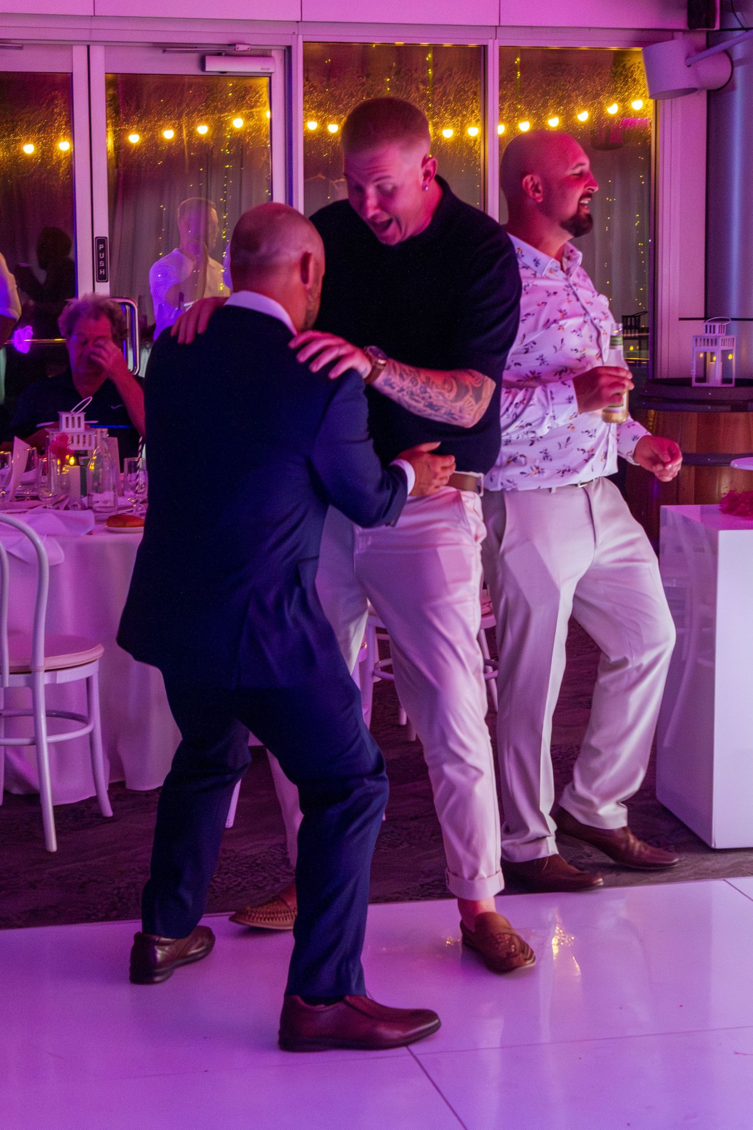 Guests celebrating on the dance floor at the wedding reception, fun party moments with friends and family taken in the Illawarra.