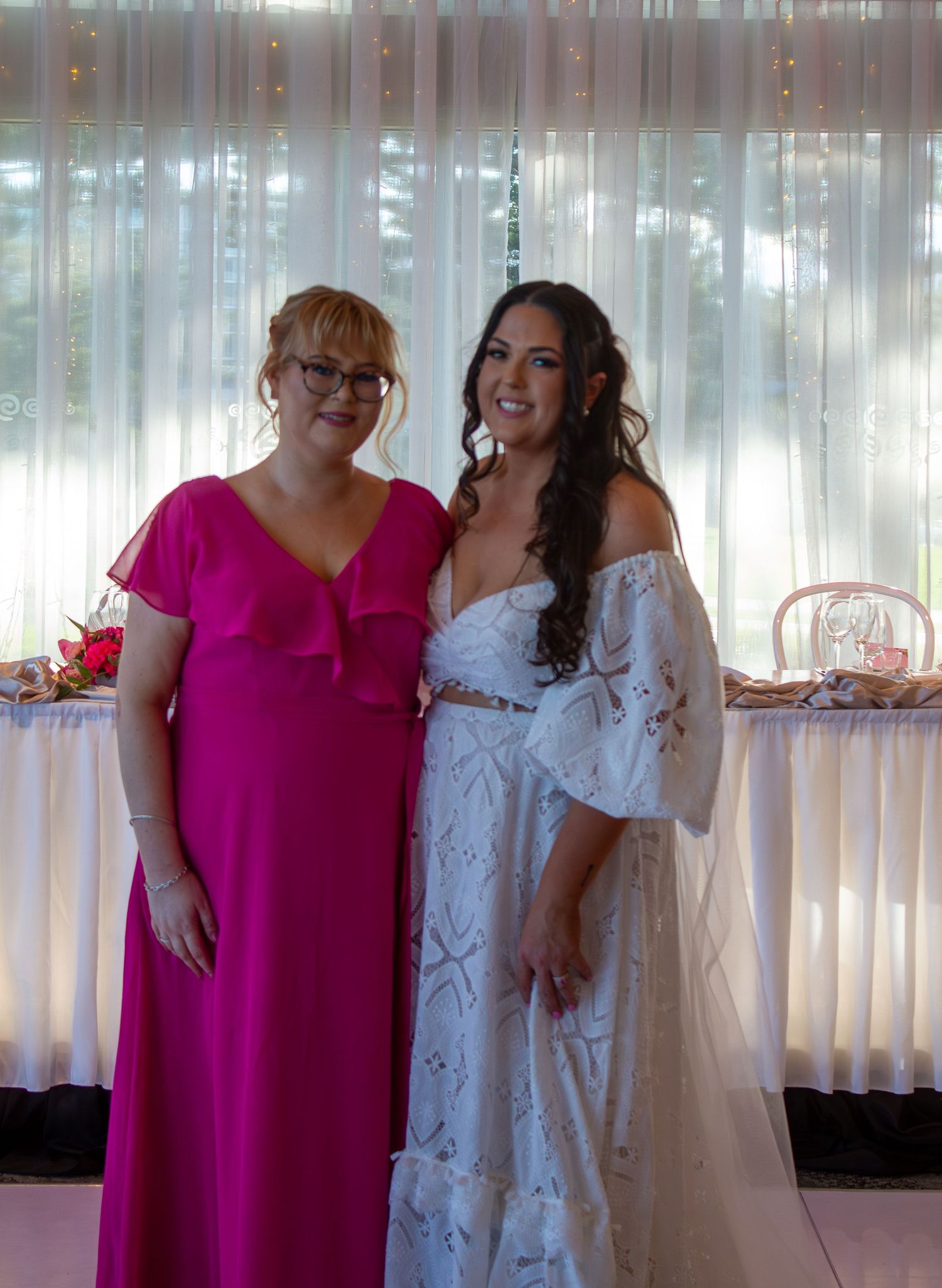 Portrait of the bride with her bridesmaid during wedding portraits, celebrating friendship on the wedding day.
