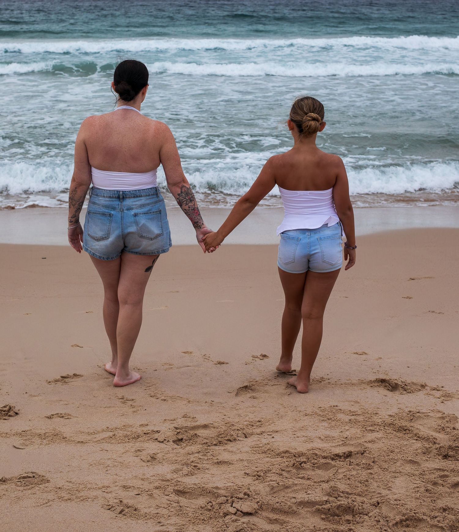 Mother holding daughter’s hand with scenic view during a motherhood session taken by A Lasting Impression Photography.