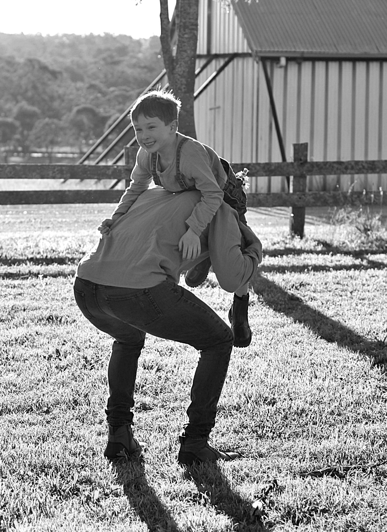Candid moment of a boy been picked up and laughing during a family session