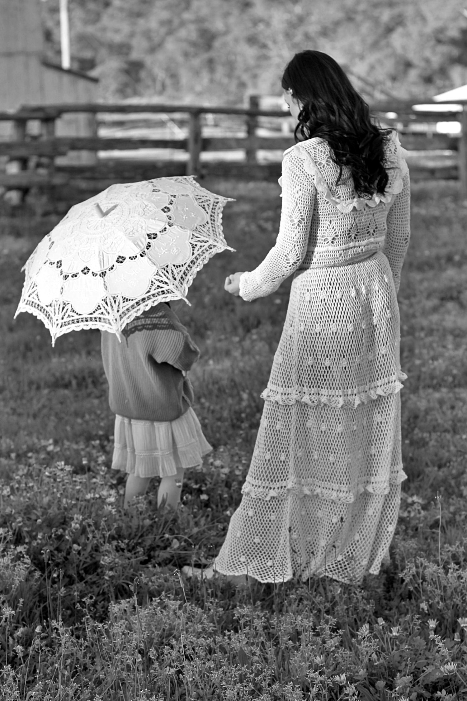 Behind the scenes style photo of mum and daughter strolling outdoors