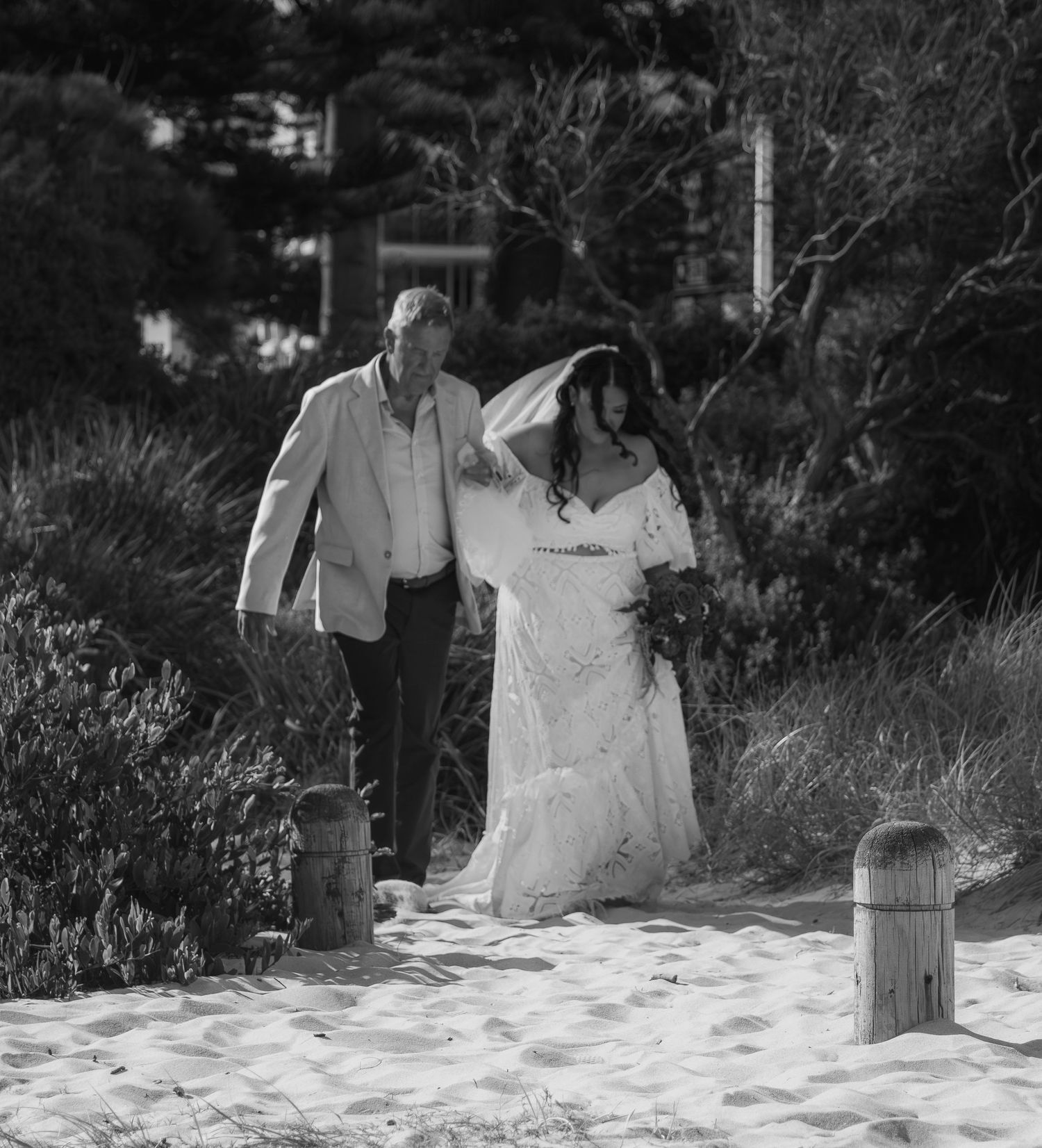 Bride walking down the aisle with her father during a beautiful Illawarra beach wedding ceremony.