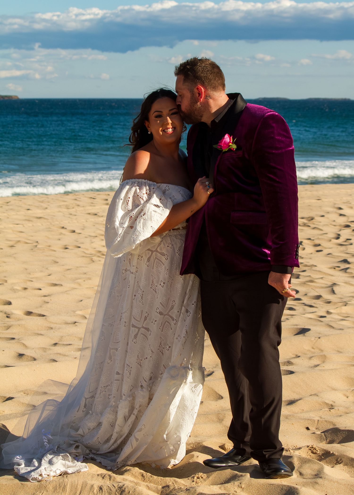 Bride and groom romantic portrait on the beach after ceremony.