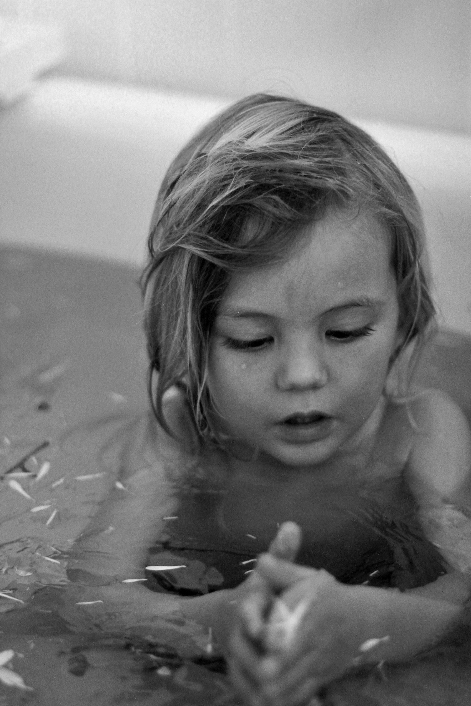 Young boy splashing in the bath during a lifestyle motherhood session at home by A Lasting Impression Photography.