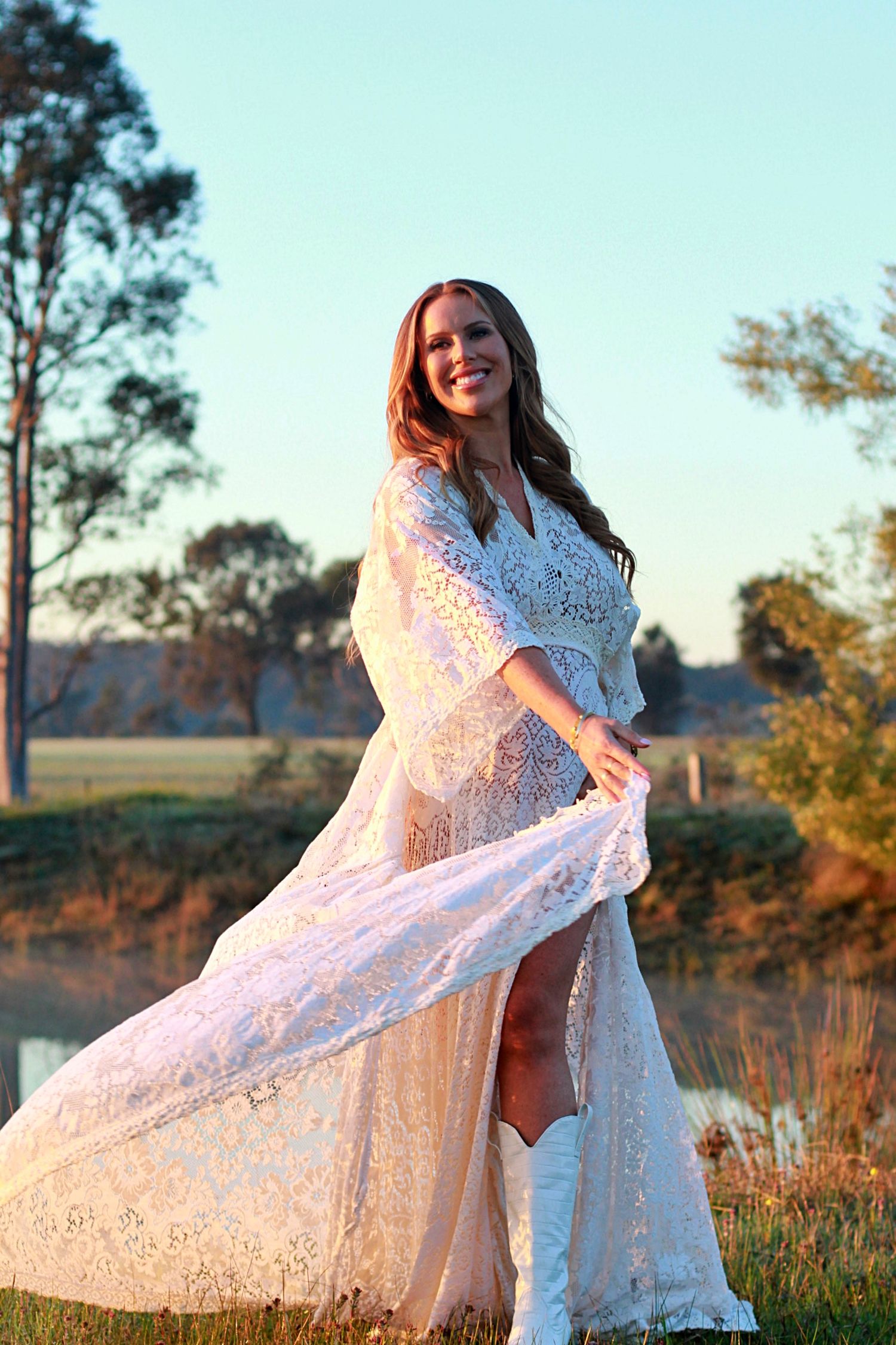 Expecting mum captured at sunrise, joyfully spinning her dress
