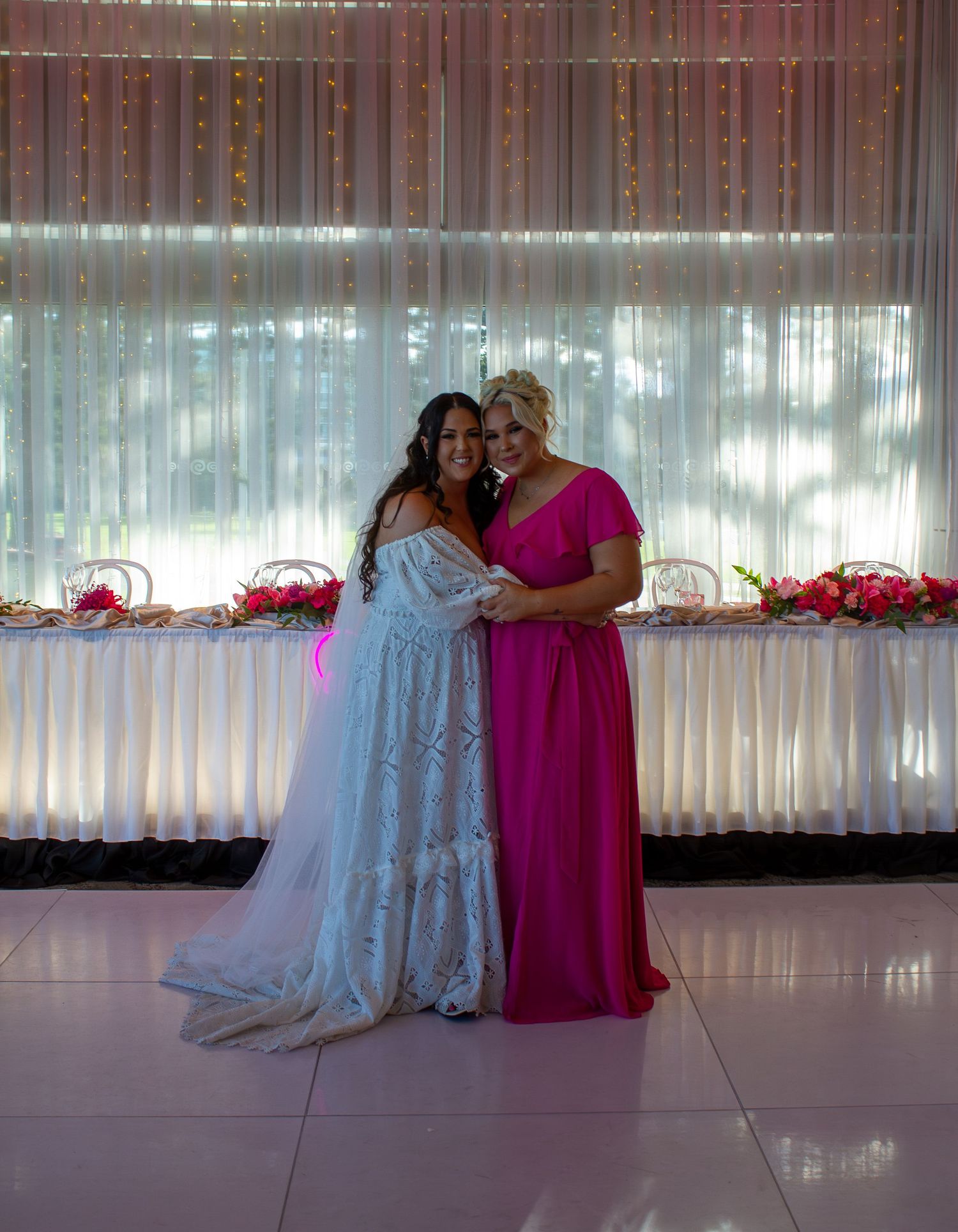 Portrait of the bride with her bridesmaid during wedding portraits, celebrating friendship on the wedding day.