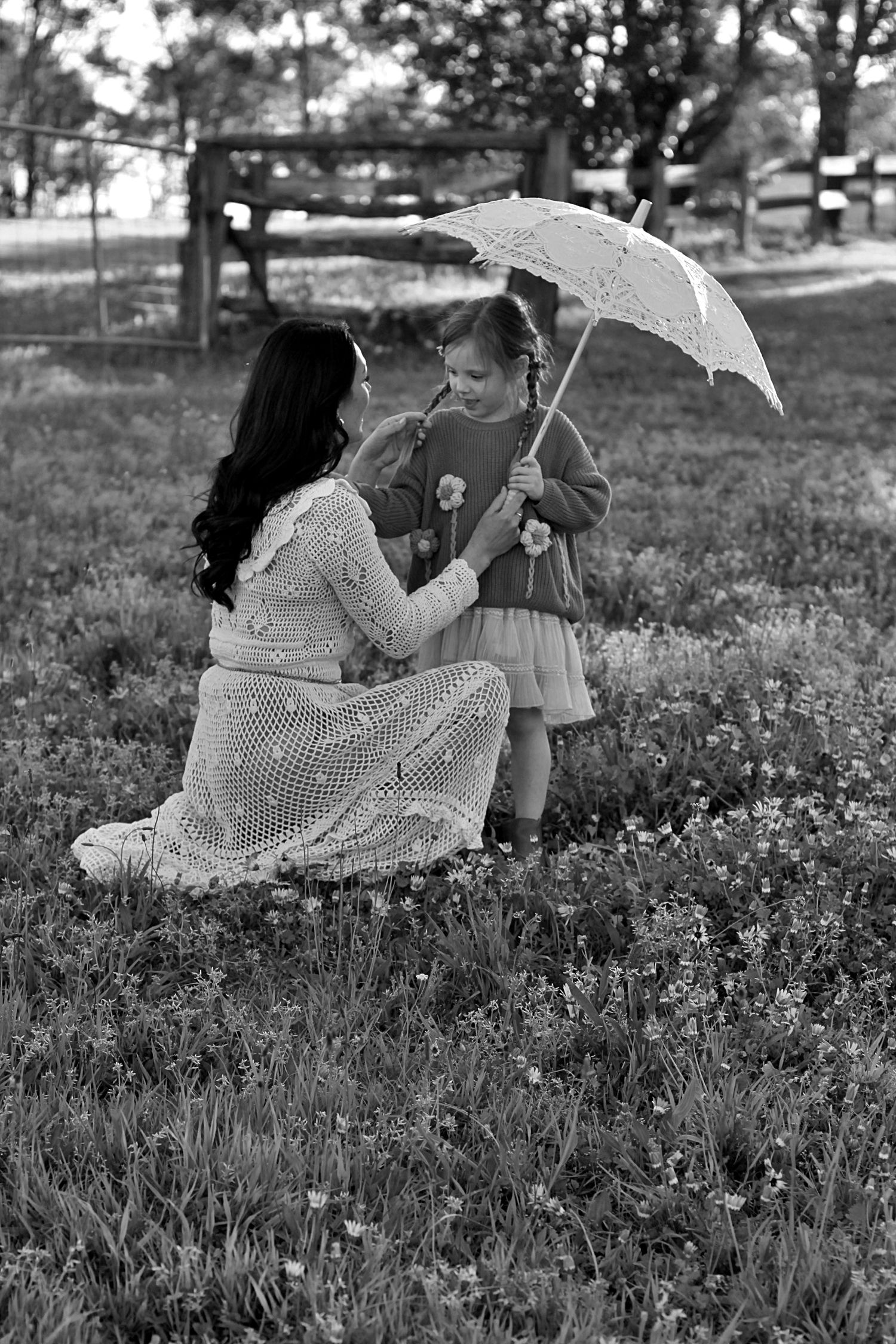 Mum and daughter sharing a quiet moment in nature during a family session
